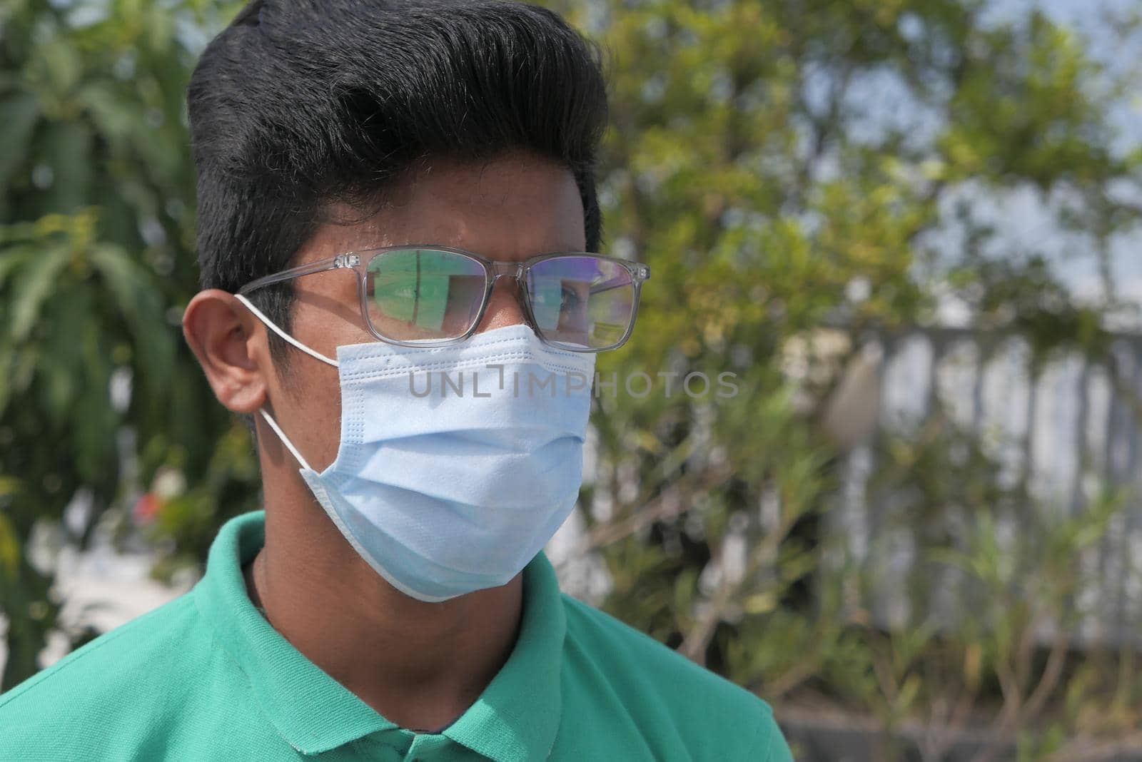 thoughtful young man with protective mask outdoor .