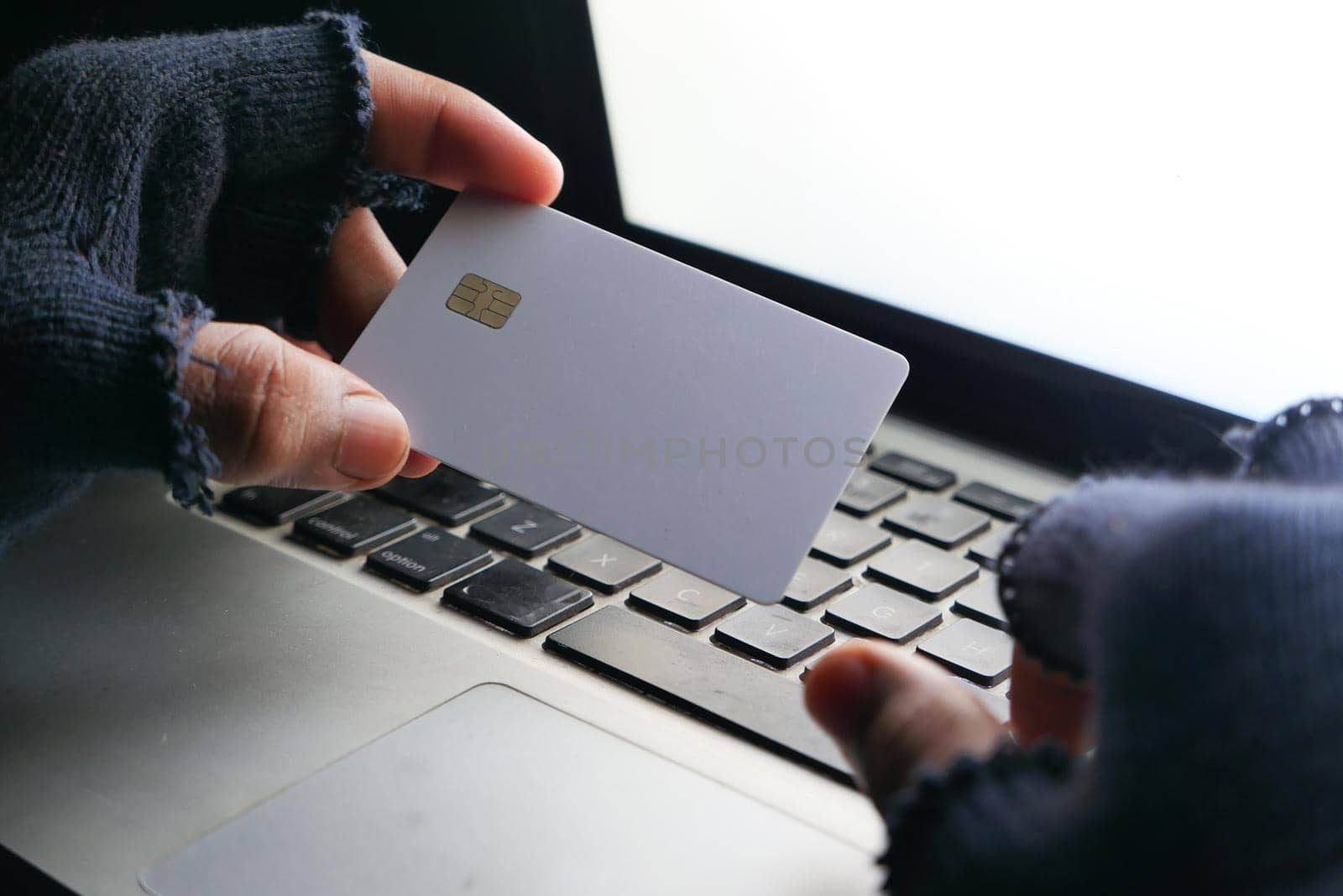 hacker hand stealing data from credit card .