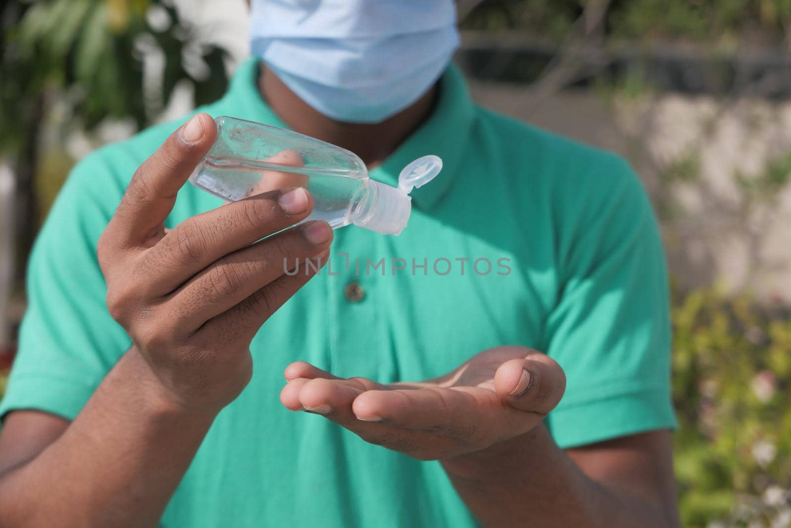 close up of young man hand using sanitizer gel for preventing virus.