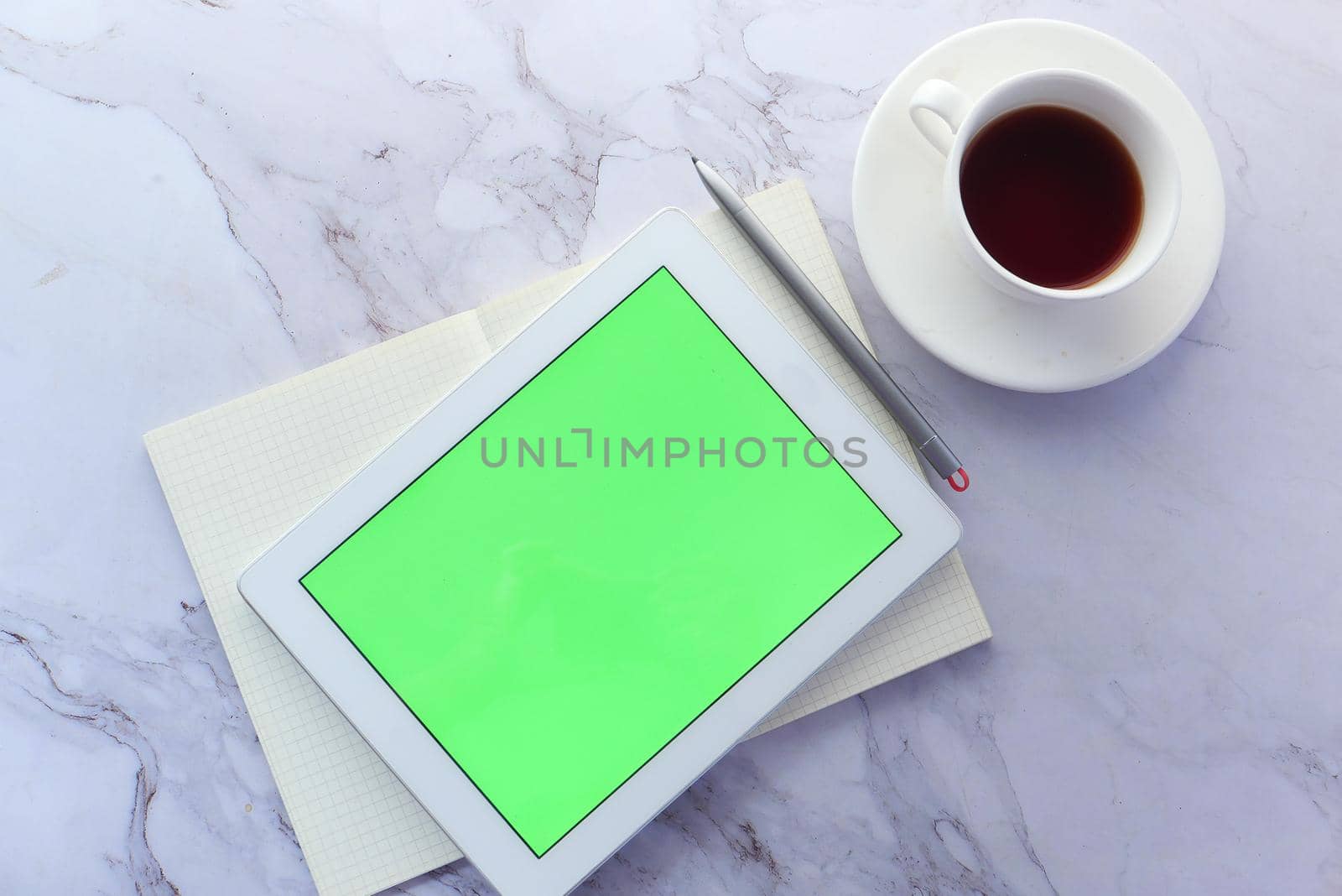 Flat composition of digital tablet and office stationary on tiles background .