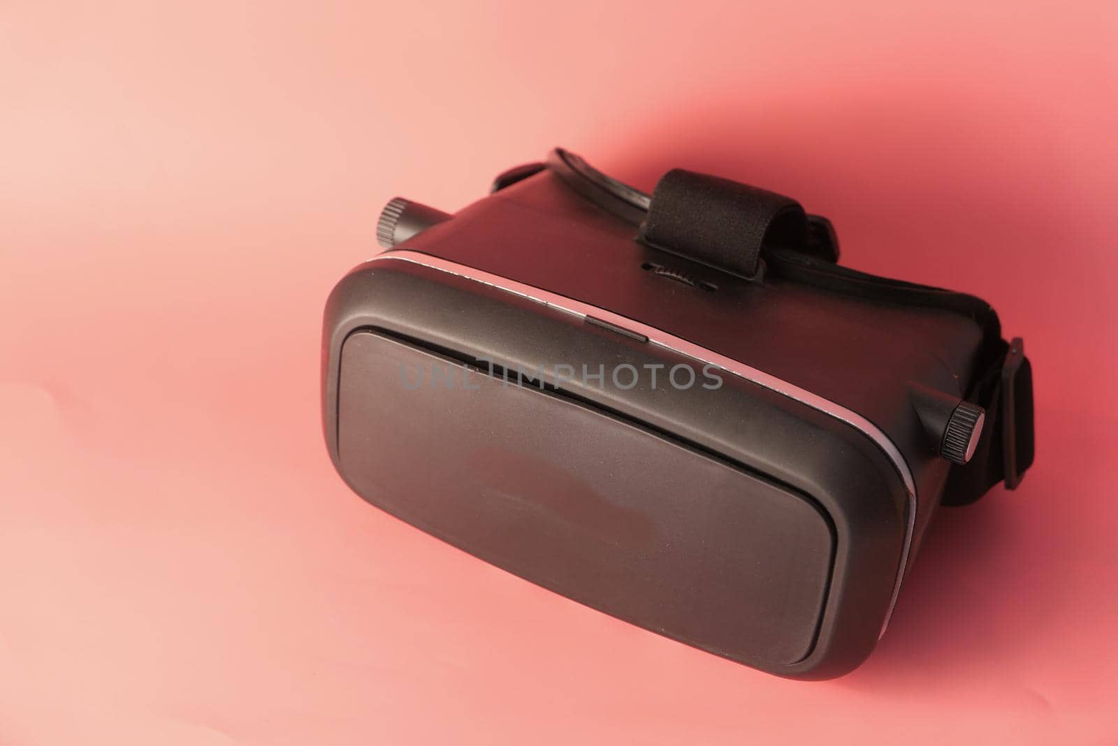 lose up of virtual reality headset, vr box on pink background .