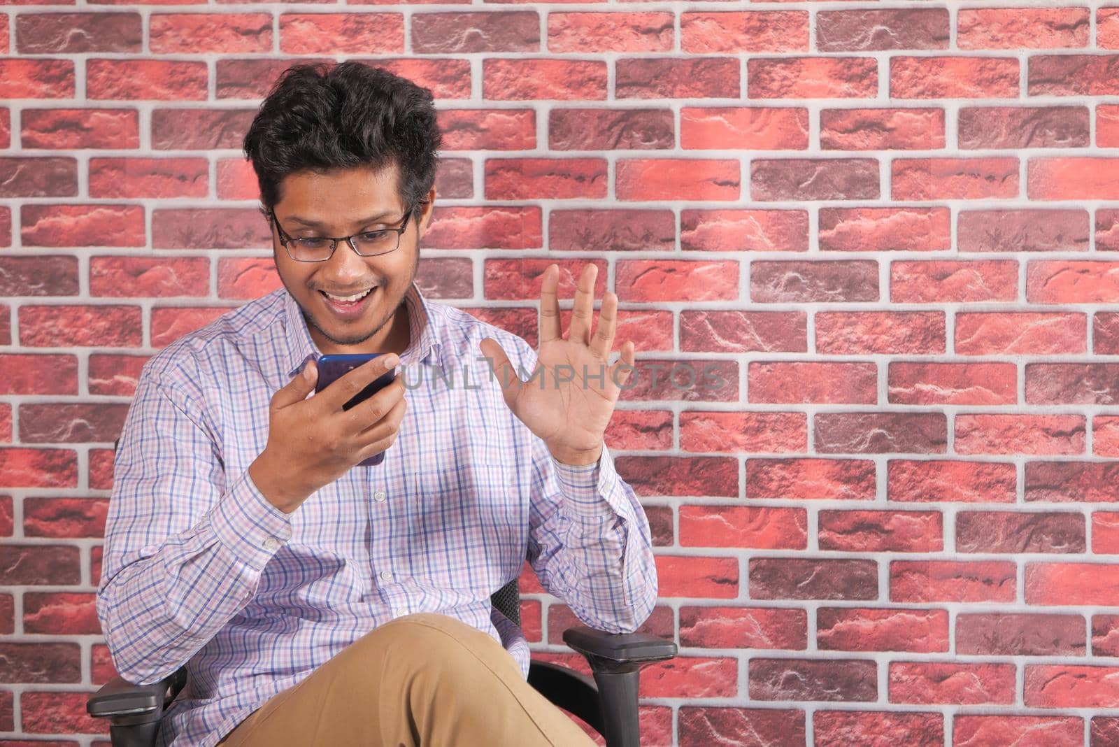 happy young man In a video conference discussing on smart phone .