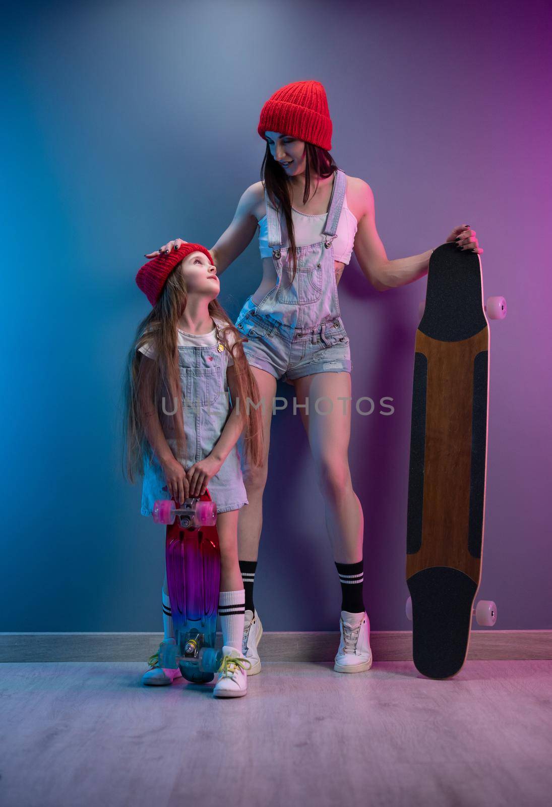 a young mother with her daughter on a skateboard and a longboard by Rotozey