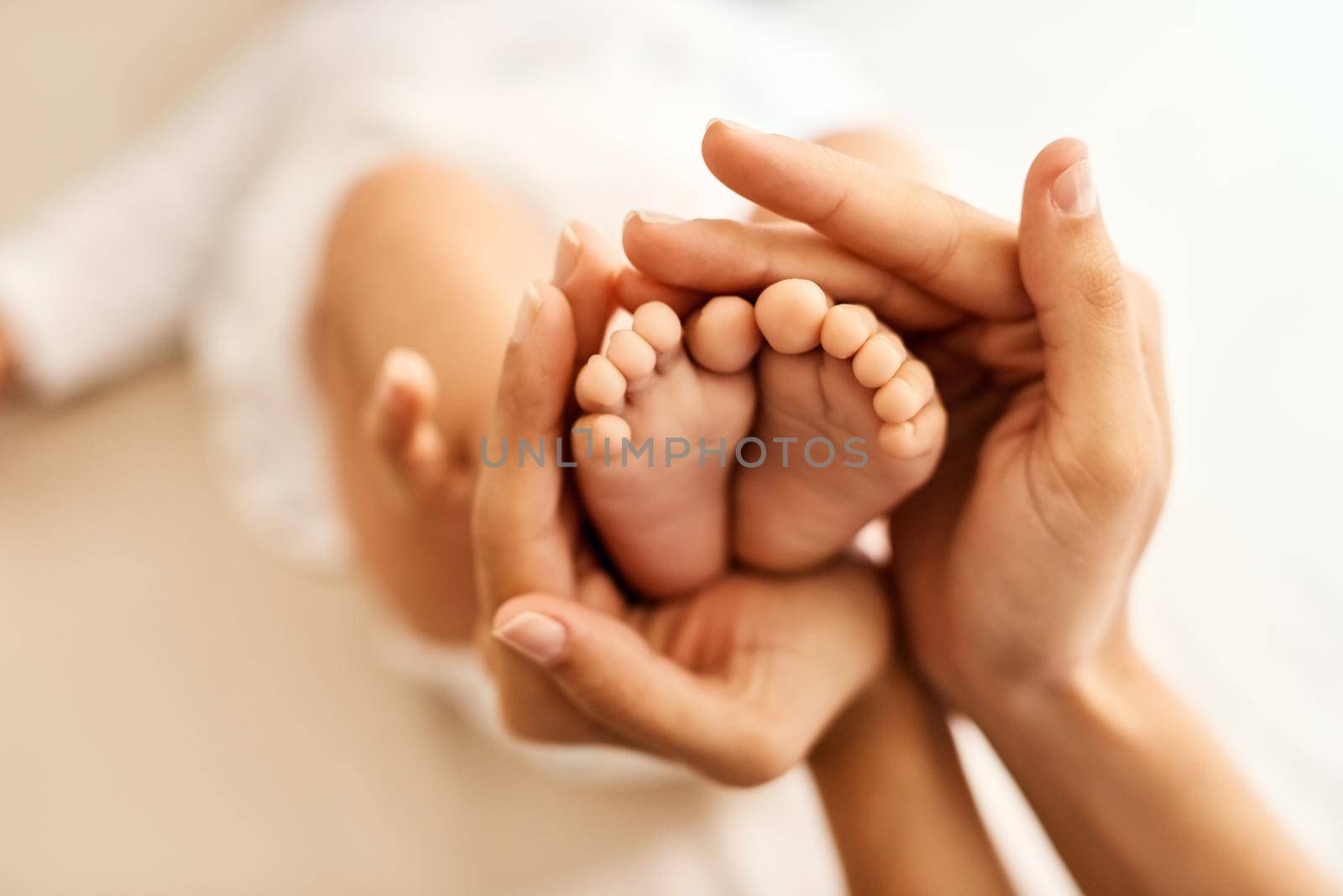 Nothing more sweet than tiny baby feet. a mother gently holding her babys feet