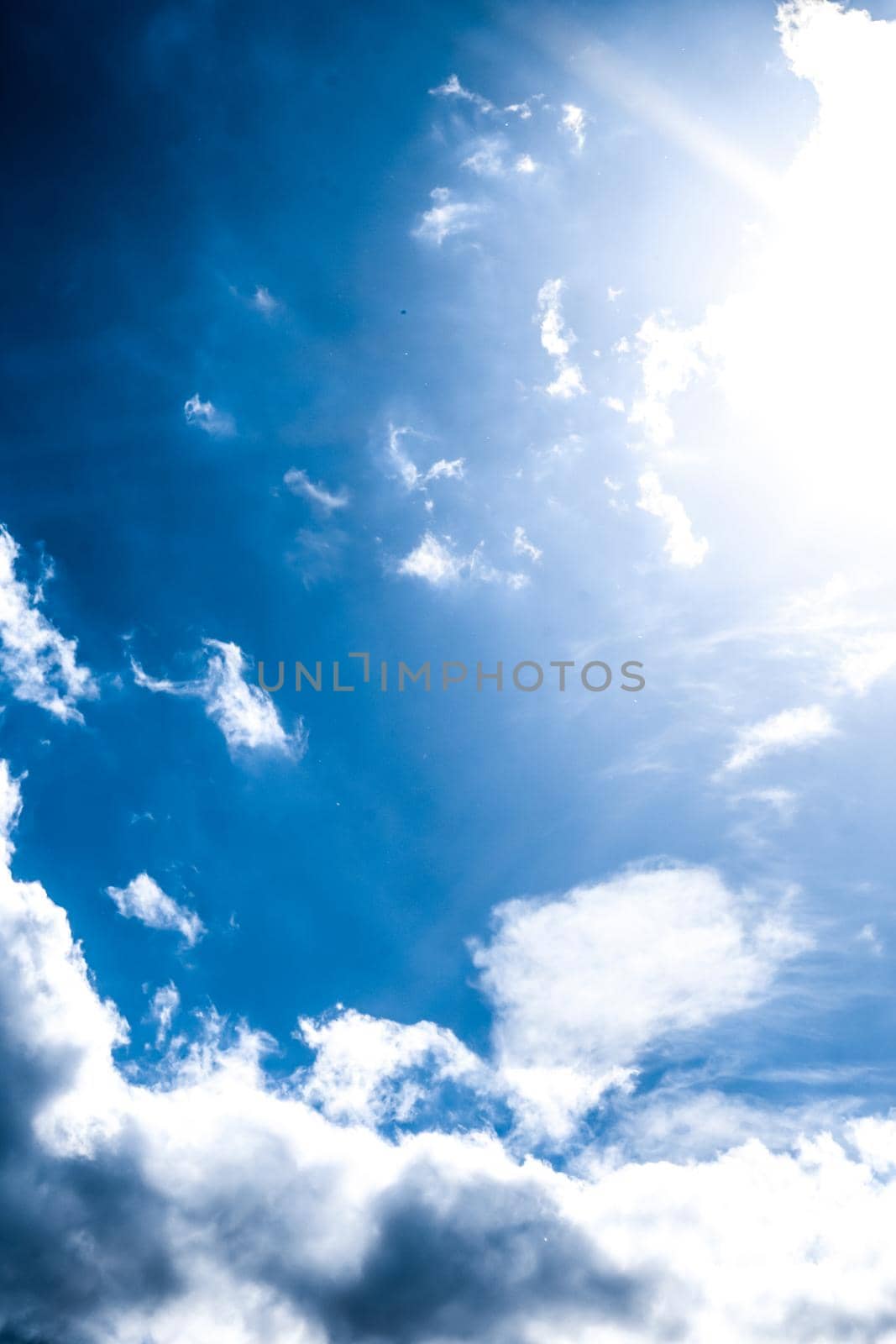 Nature backdrop, solar energy and spiritual concept - Blue sky background, white clouds and bright sunlight