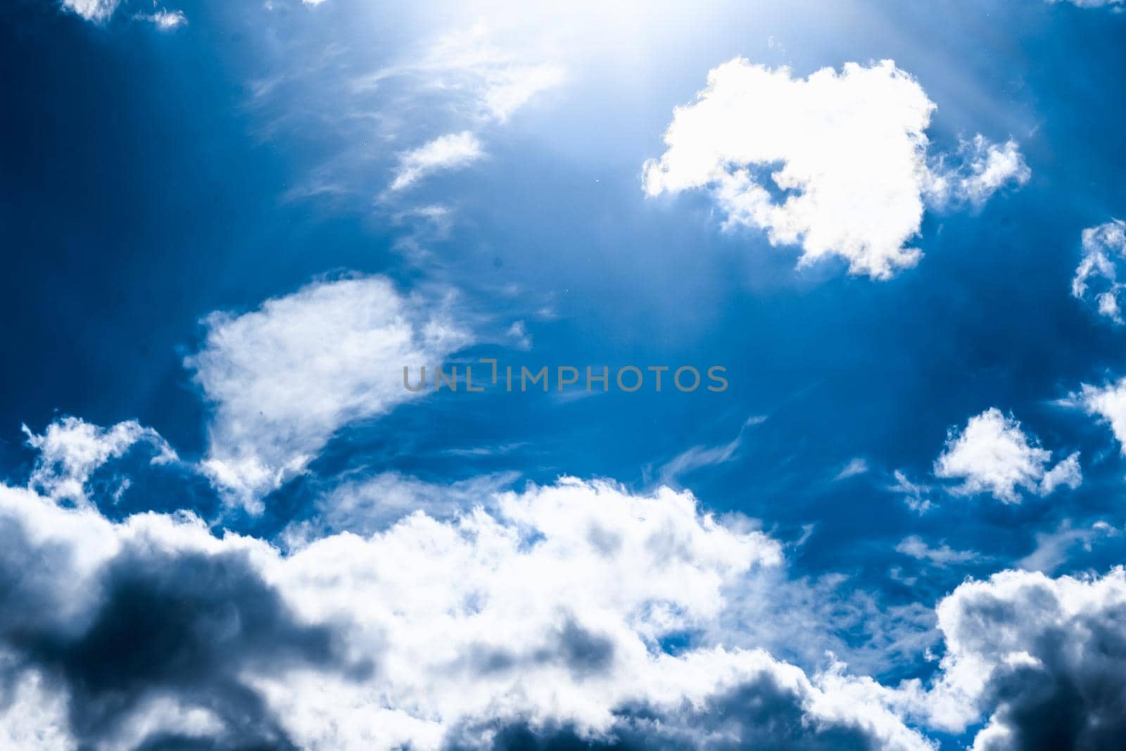 Nature backdrop, solar energy and spiritual concept - Blue sky background, white clouds and bright sunlight