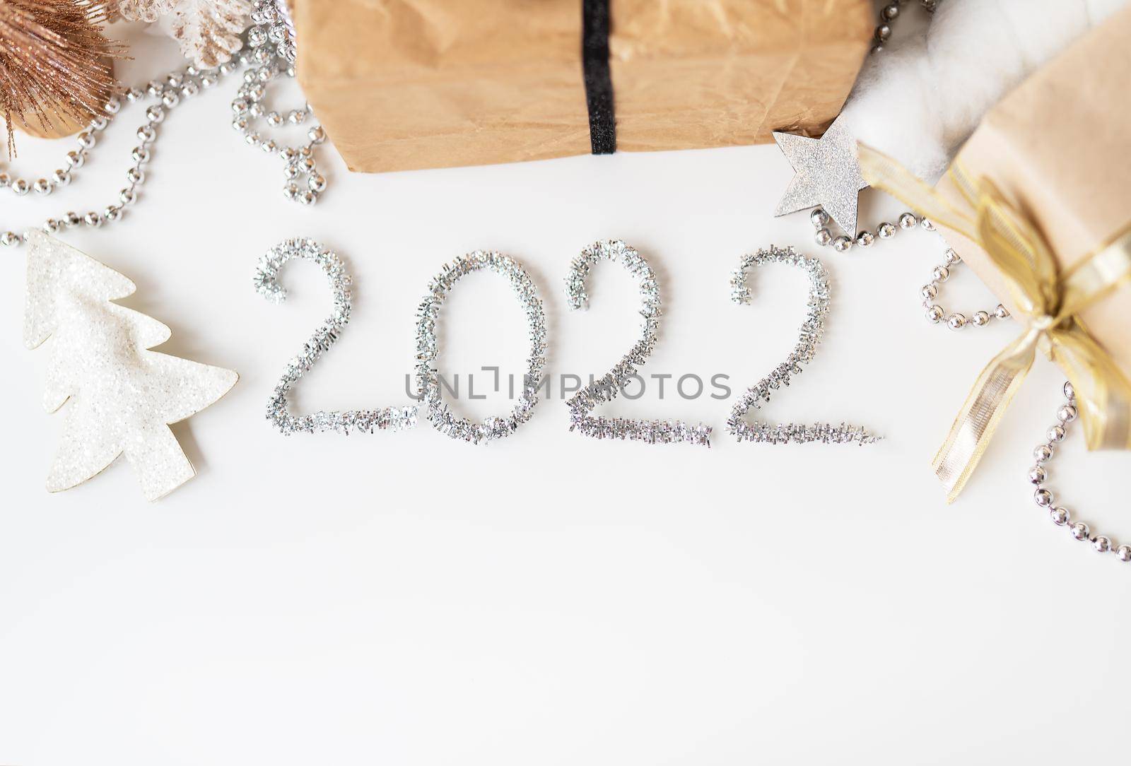 Happy New Year 2022. Festive decor - Christmas tree, gift, star, tinsel. Blank copy space for decal or other objects