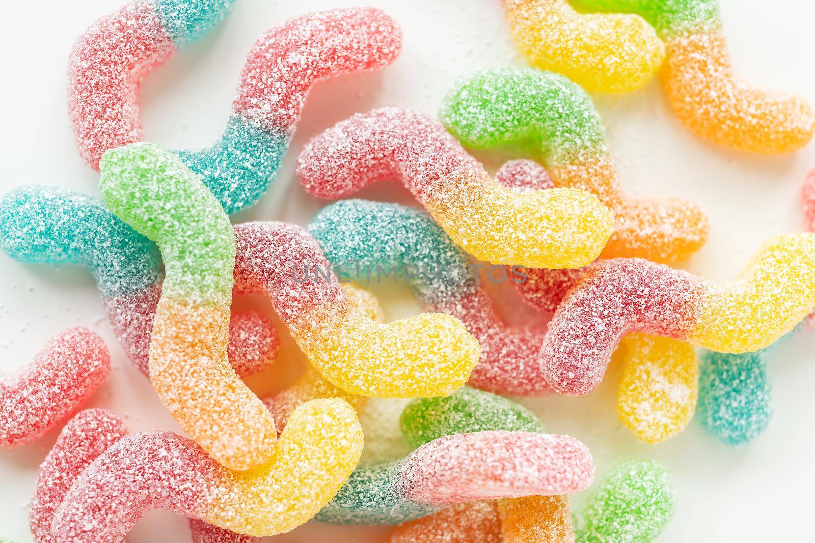 Colorful tasty jelly candies on a white background, top view
