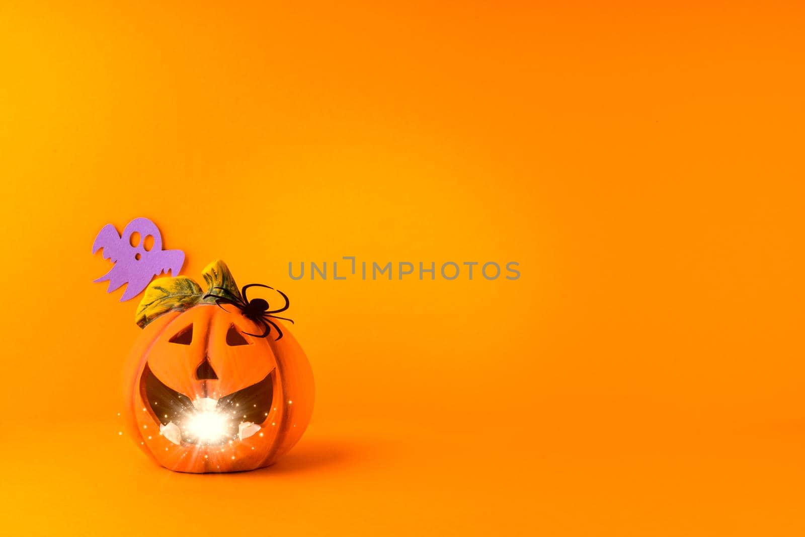 Happy halloween holiday concept. Jack o lantern, handmade paper decorations, spiders, ghosts on orange background. Halloween festival party, greeting card mockup with copy space.