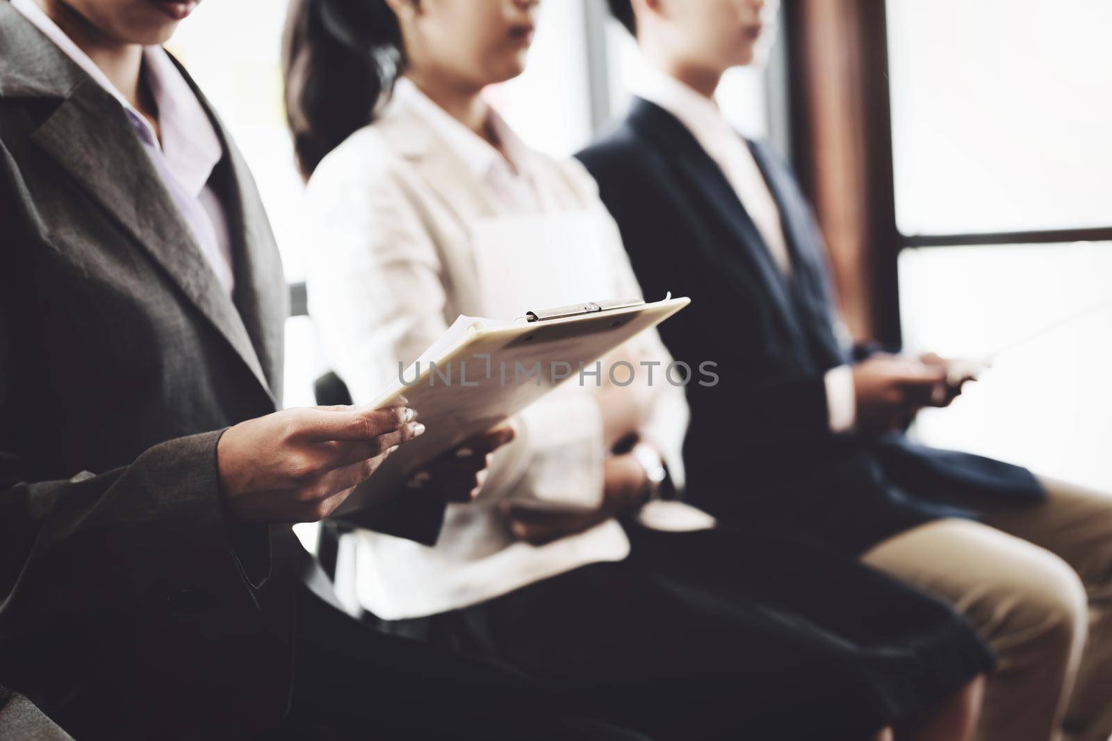 Graduate students holding resume are waiting for an interview to work with the company.