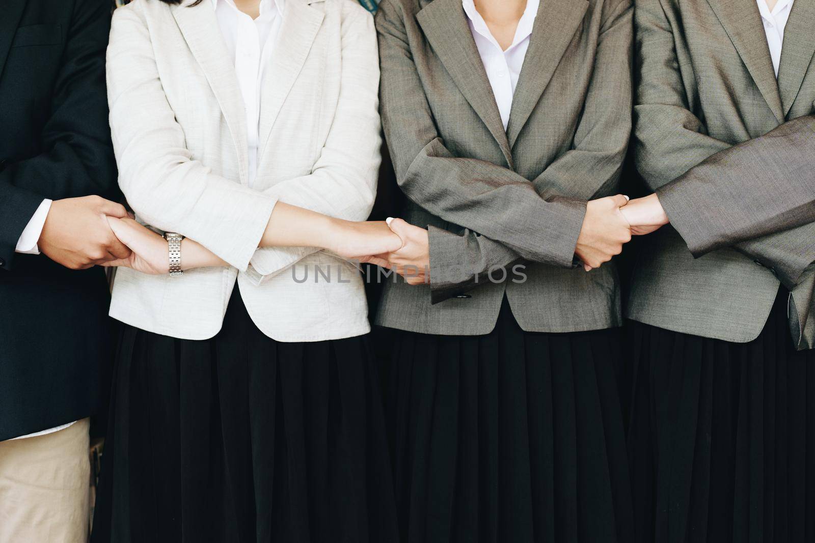 Group of business people showing merger symbol, together concept by Manastrong