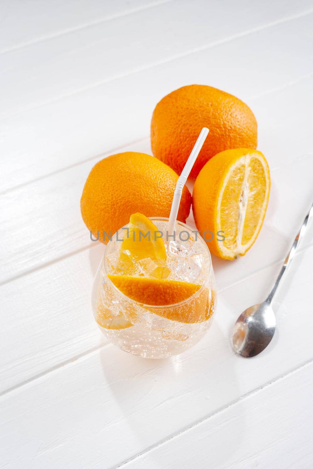 Cold fresh orange lemonade on wooden light background by gulyaevstudio