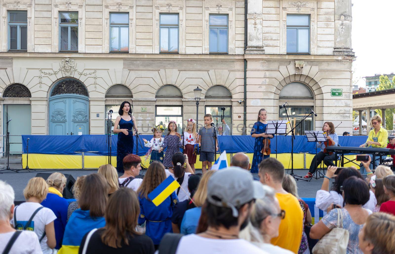 LJUBLJANA, SLOVENIA - August 24, 2022: Ukraine independence day meeting. People with flags and national symbols by Chechotkin