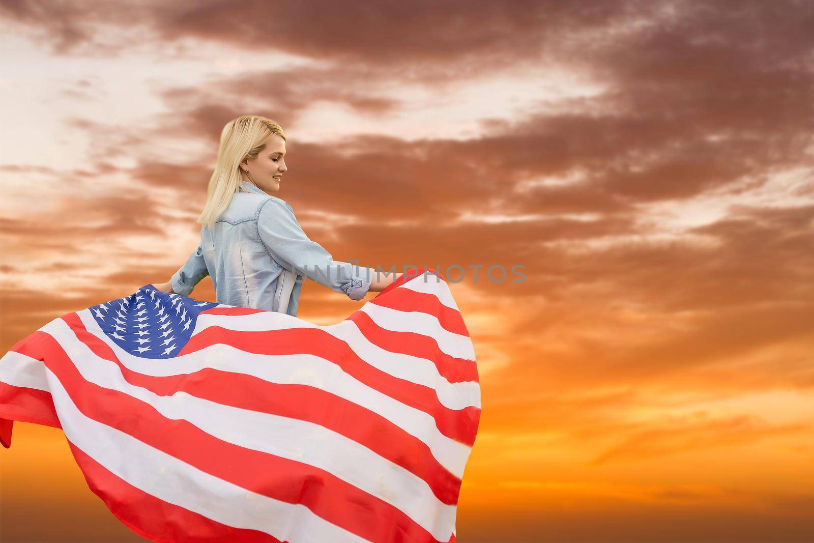 Young cute woman holding an united states flag.