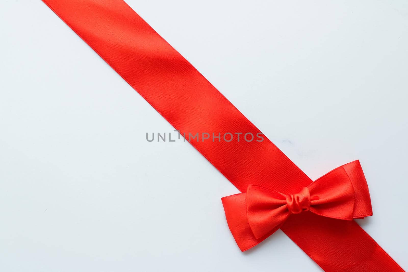 Red silk ribbon on marble, top view by Anneleven