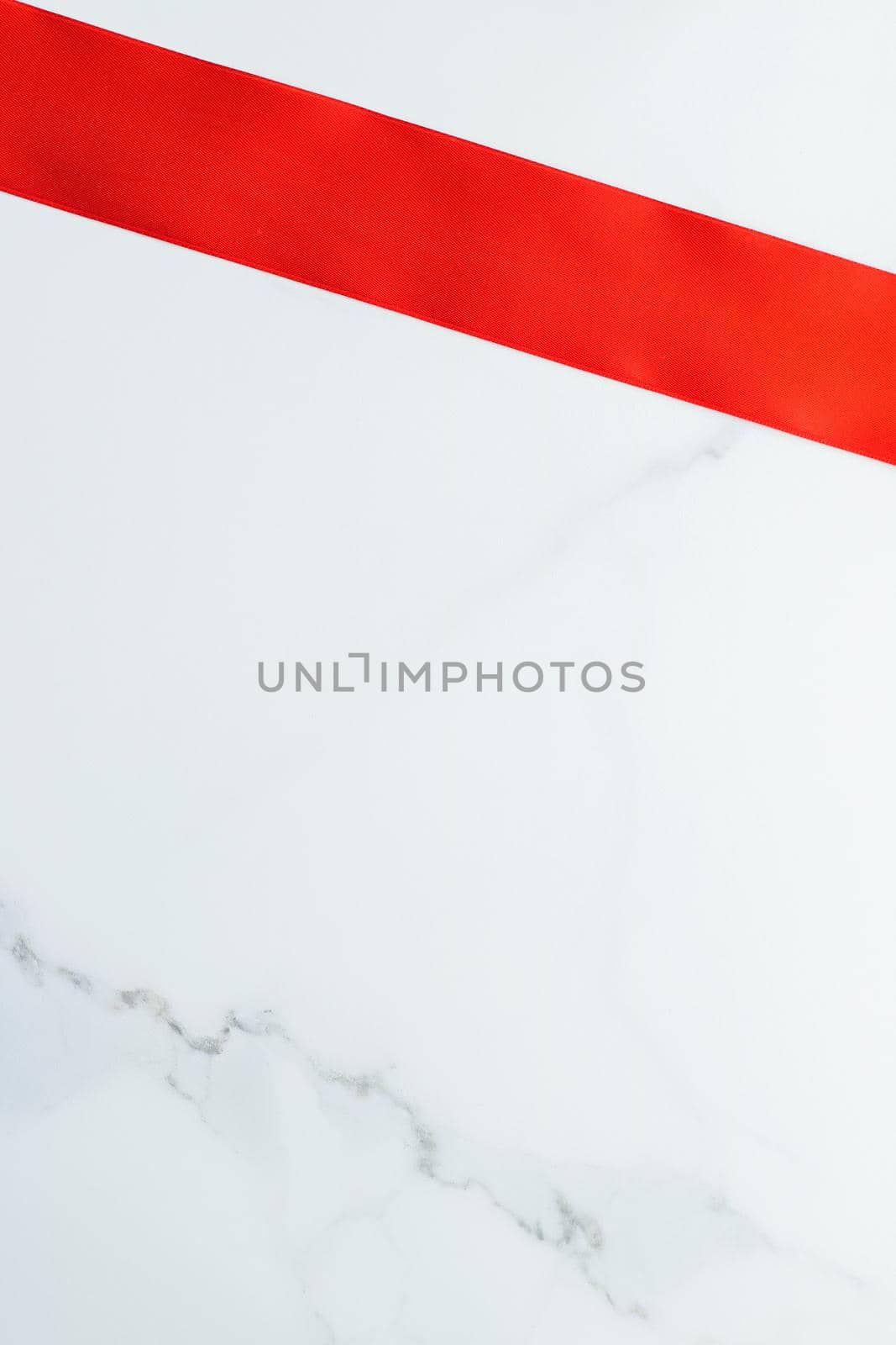 Holiday decor, feminine design and flatlay concept - Red silk ribbon on marble, top view