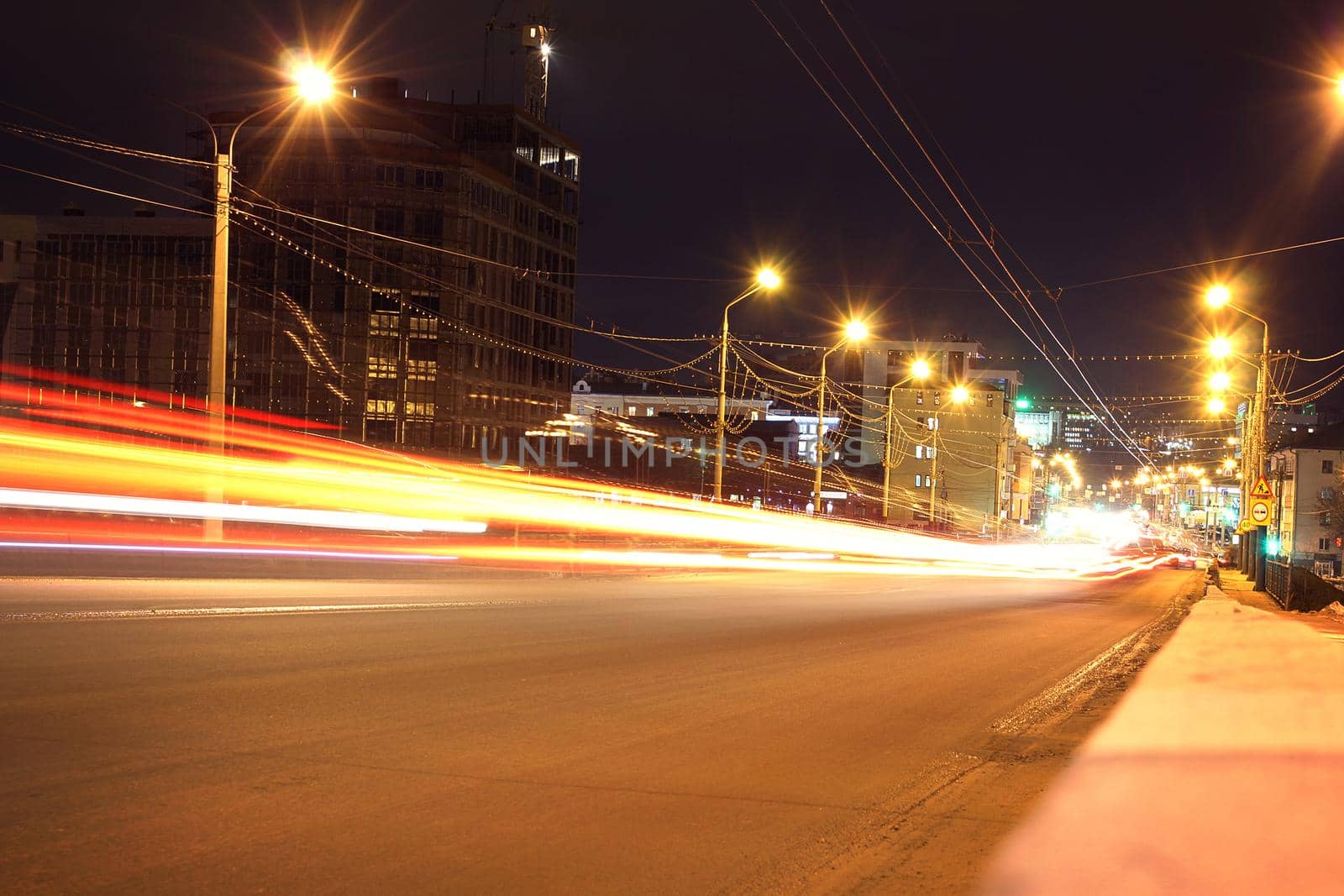 Speed Traffic at Dramatic Sundown Time - light trails on motorway highway at night, long exposure urban background