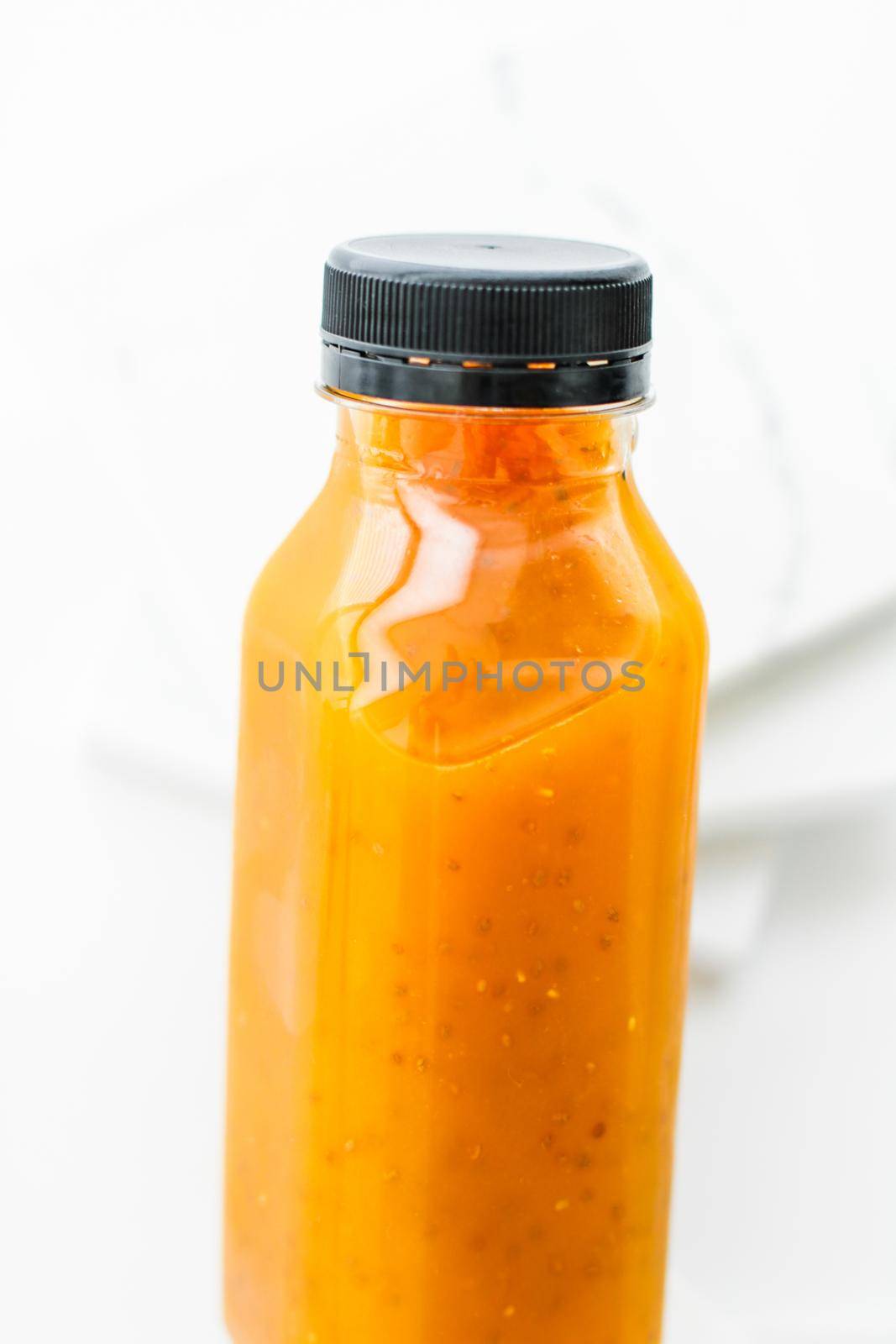 Healthy nutrition, organic drink and fasting cleanse concept - Detox fruit smoothie juice in a bottle, diet catering delivery. Isolated on white background