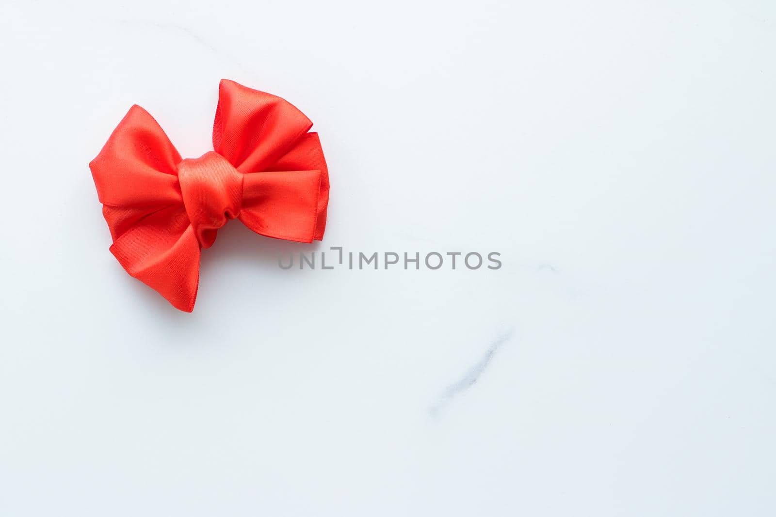 Red silk ribbon on marble, top view by Anneleven