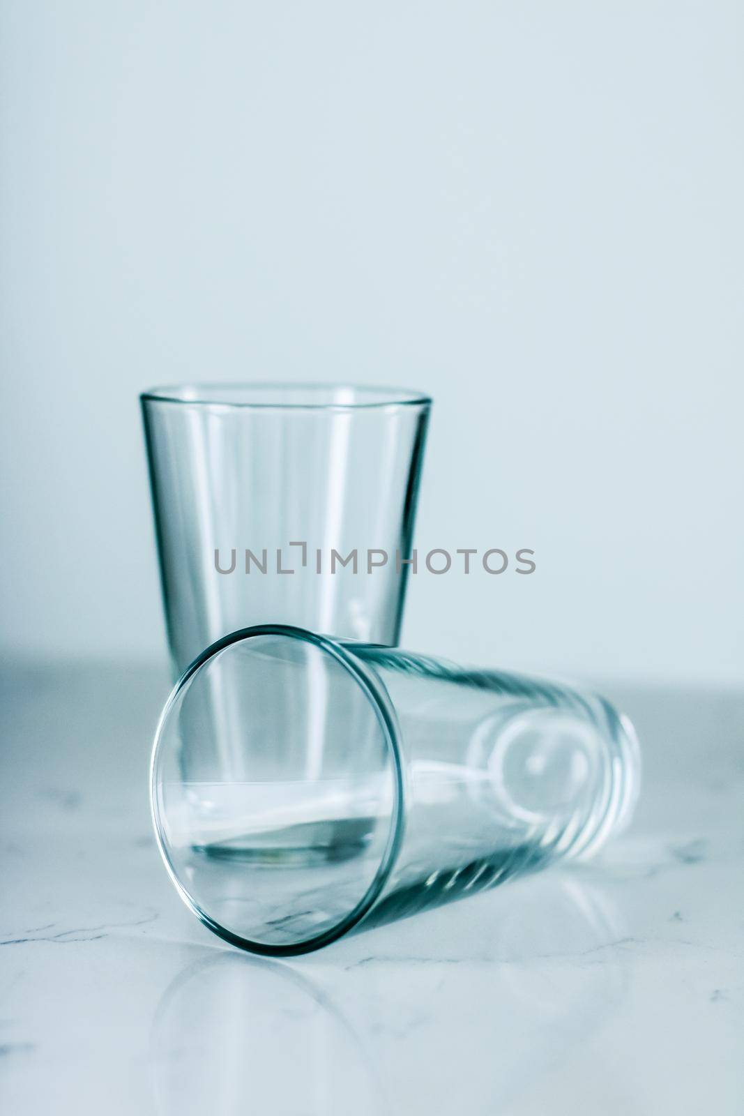 Glassware, washing and purity concept - Clean empty glasses on marble table