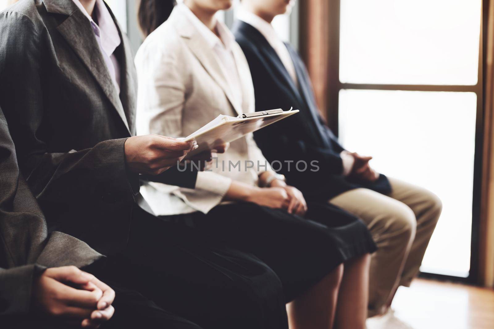 Graduate students holding resume are waiting for an interview to work with the company.