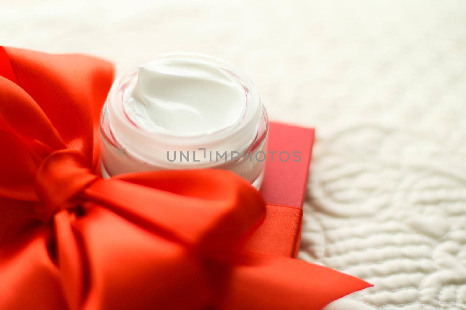 Beauty, cosmetics and skincare styled concept - Luxury face cream jar and red gift box