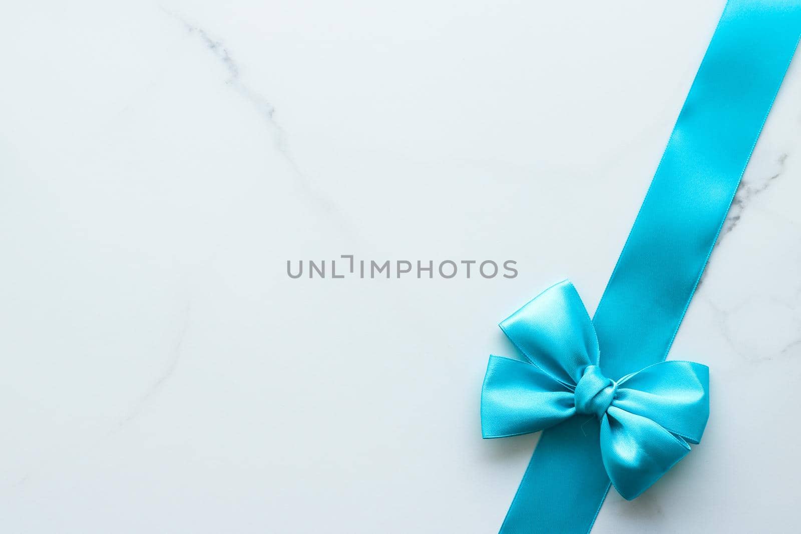 Holiday decor, feminine design and flatlay concept - Blue silk ribbon on marble, top view