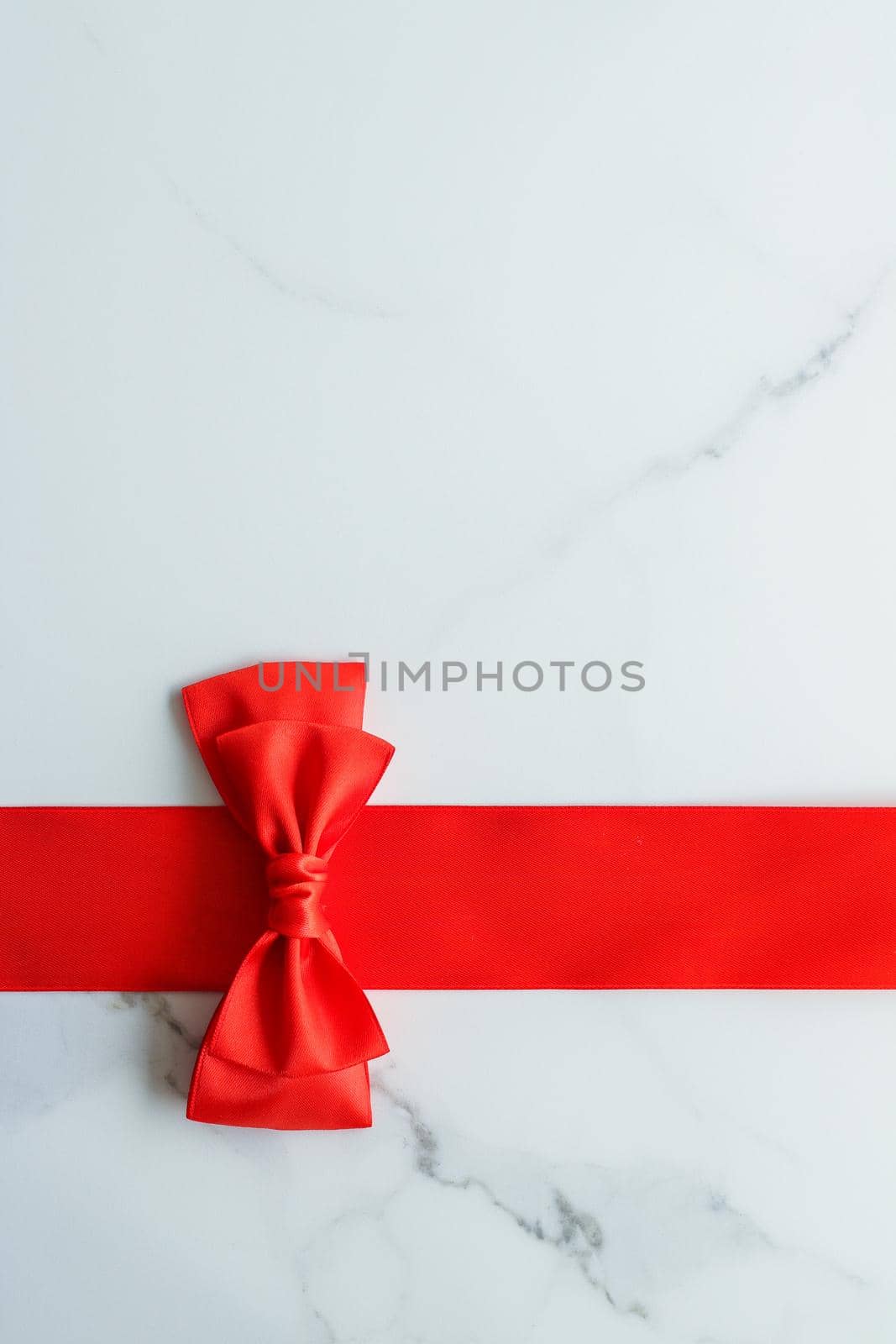 Red silk ribbon on marble, top view by Anneleven