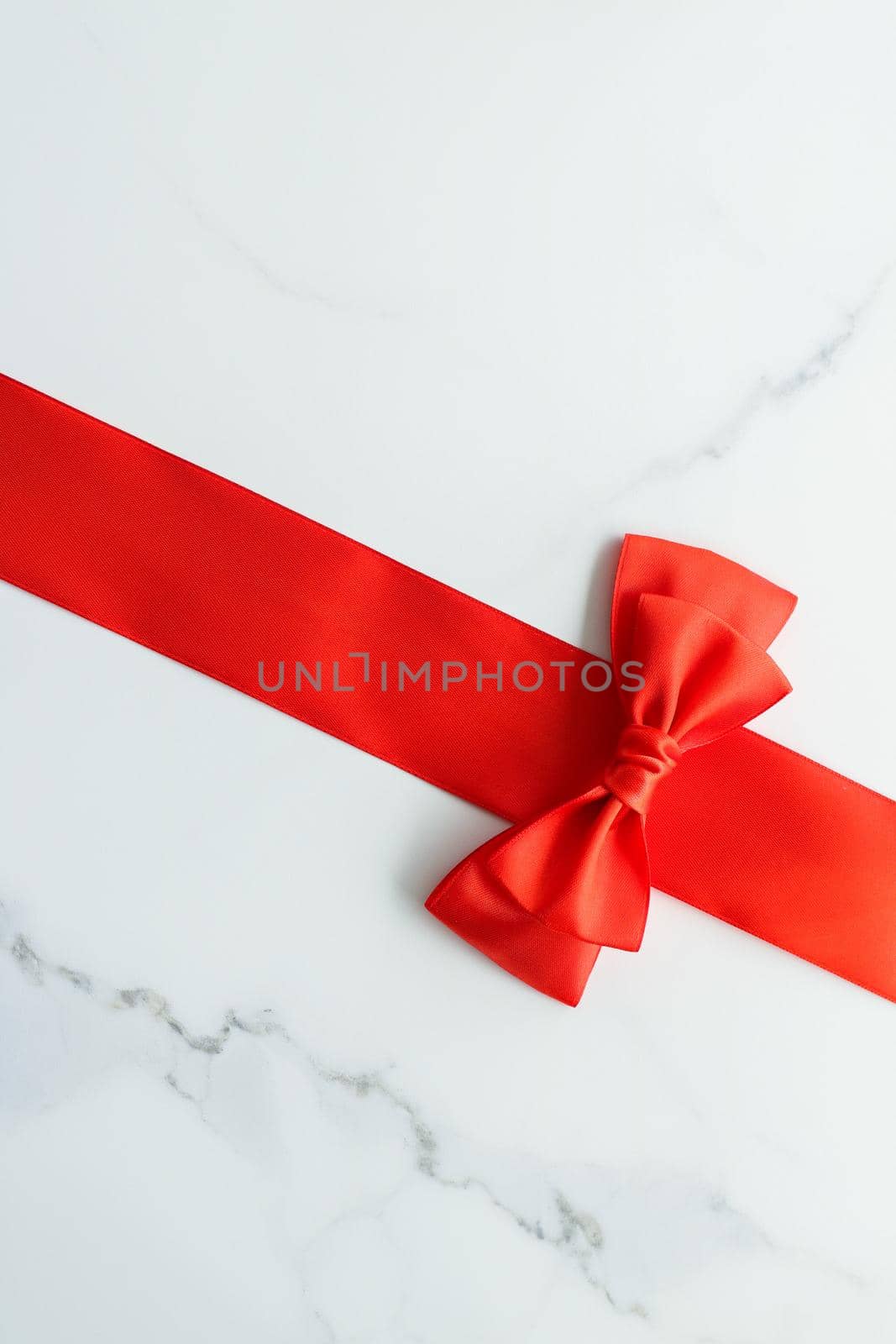 Holiday decor, feminine design and flatlay concept - Red silk ribbon on marble, top view