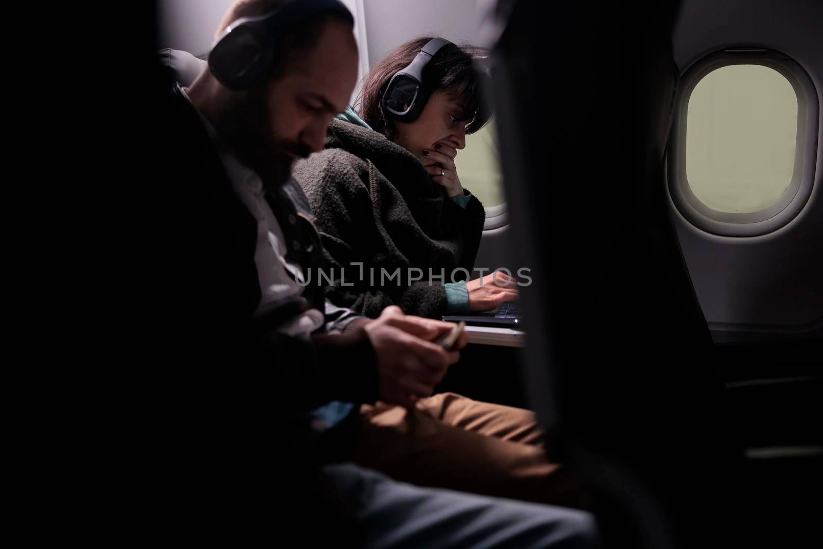 Group of passengers flying together on plane in economy class by DCStudio