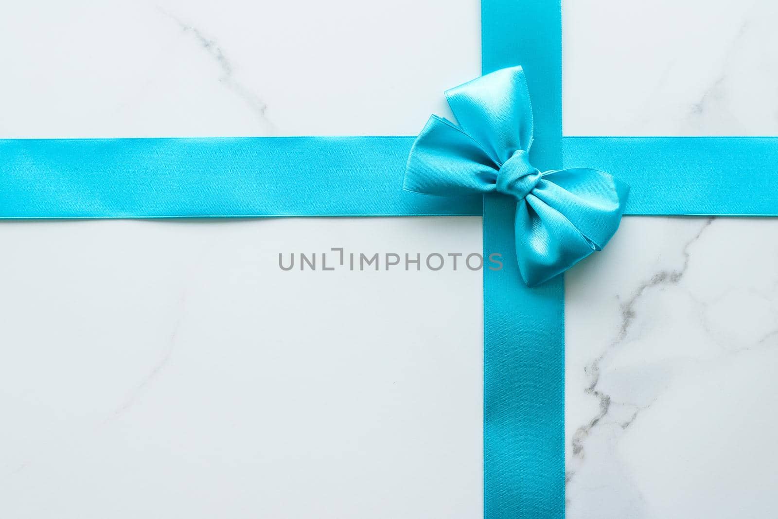 Holiday decor, feminine design and flatlay concept - Blue silk ribbon on marble, top view