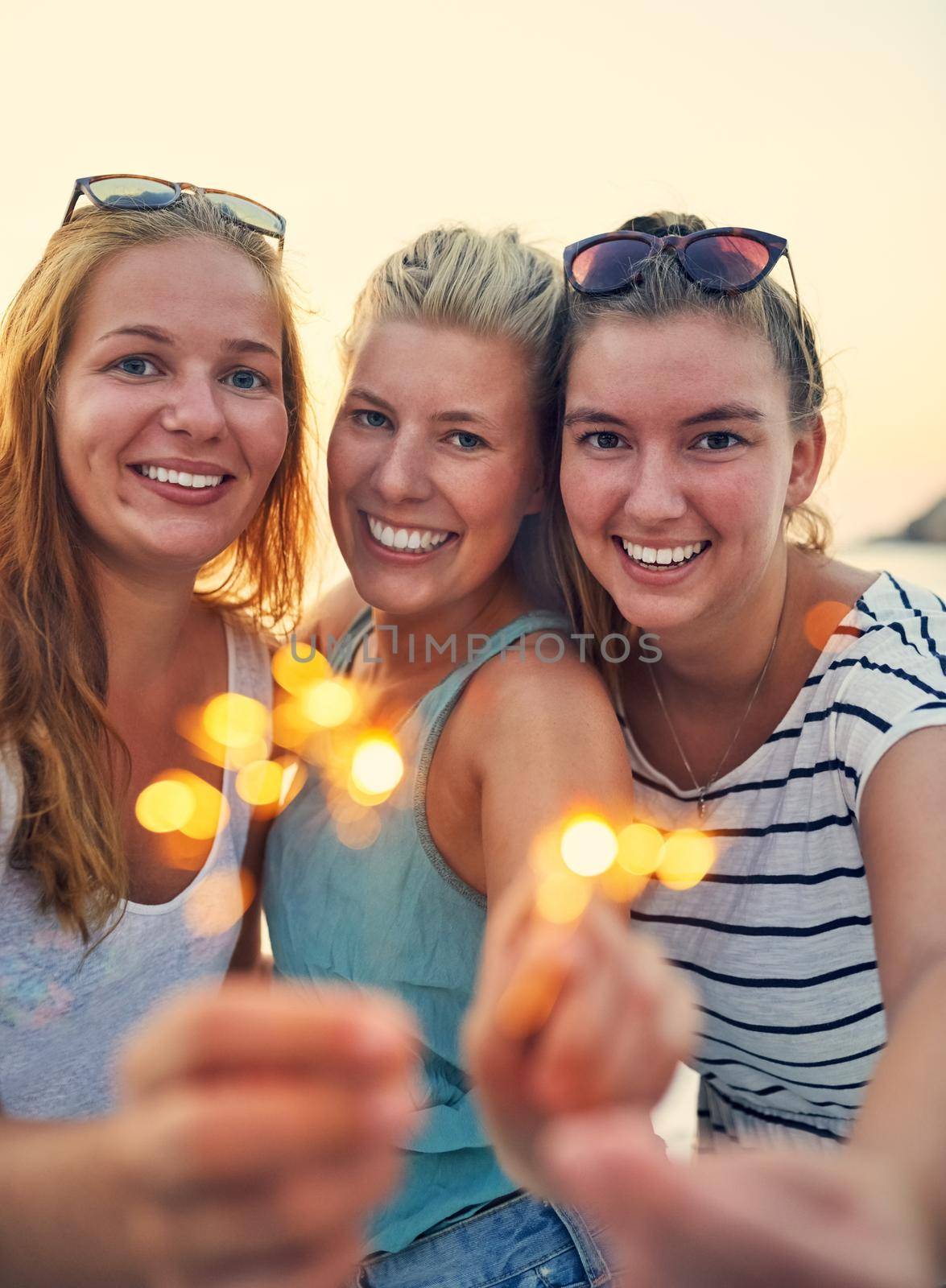 Our friendship is as bright as a sparkler. young female best friends hanging out at the beach