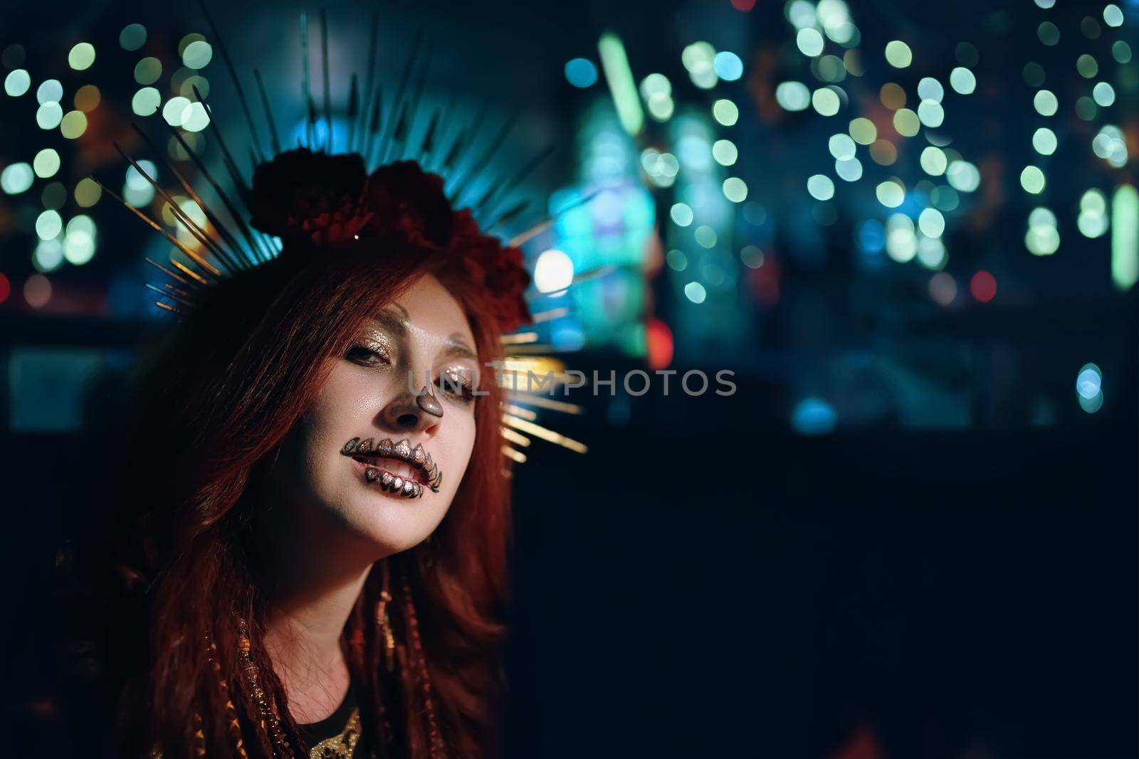 Woman with skeleton makeup at a Halloween party. Celebration in a nightclub. Female in creepy costume of Mexican goddess of death. All Saints' Night.