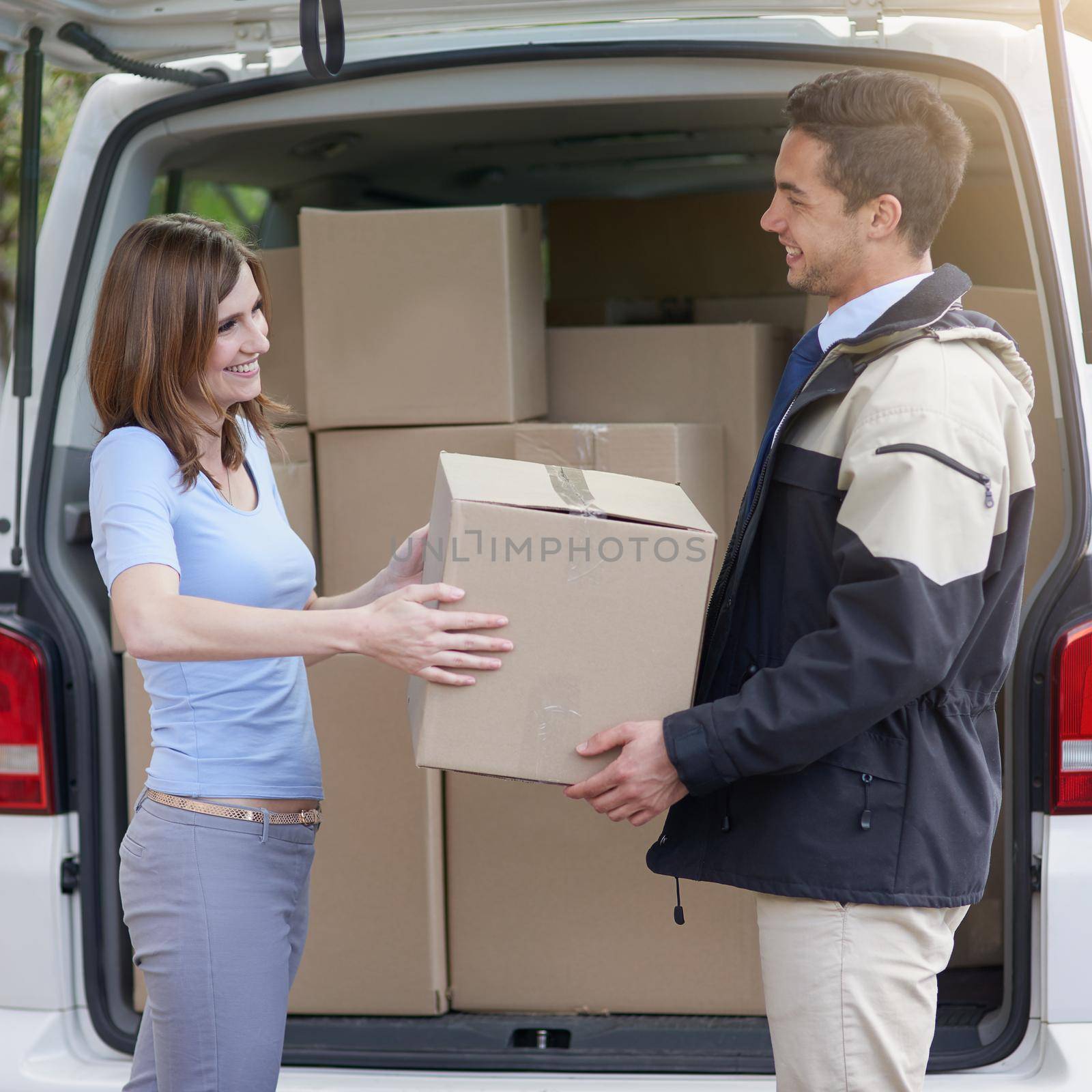 Hes committed to great customer service. a delivery man making a delivery to a customer at her home