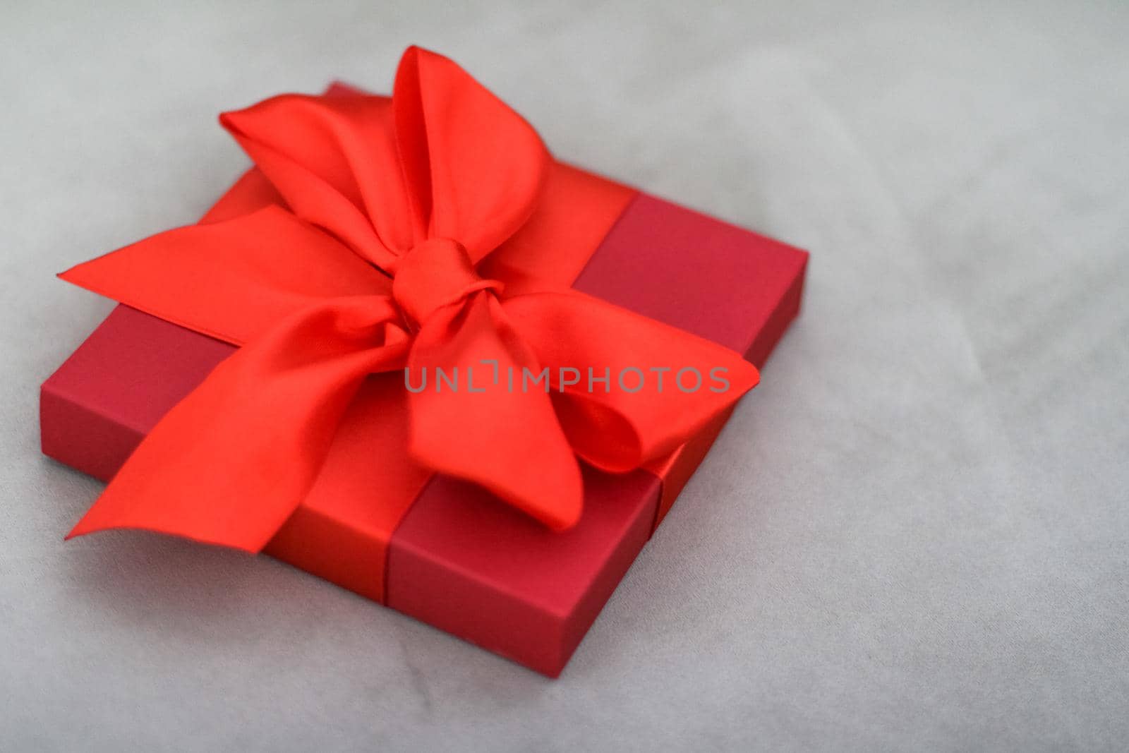 Luxury holiday red gift box with silk ribbon and bow, christmas or valentines day decor by Anneleven