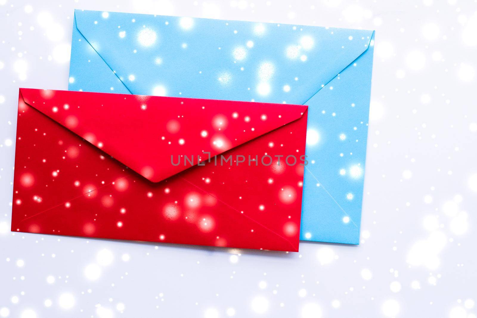 Greetings, postal service and online newsletter concept - Winter holiday blank paper envelopes on marble with shiny snow flatlay background, love letter or Christmas mail card design