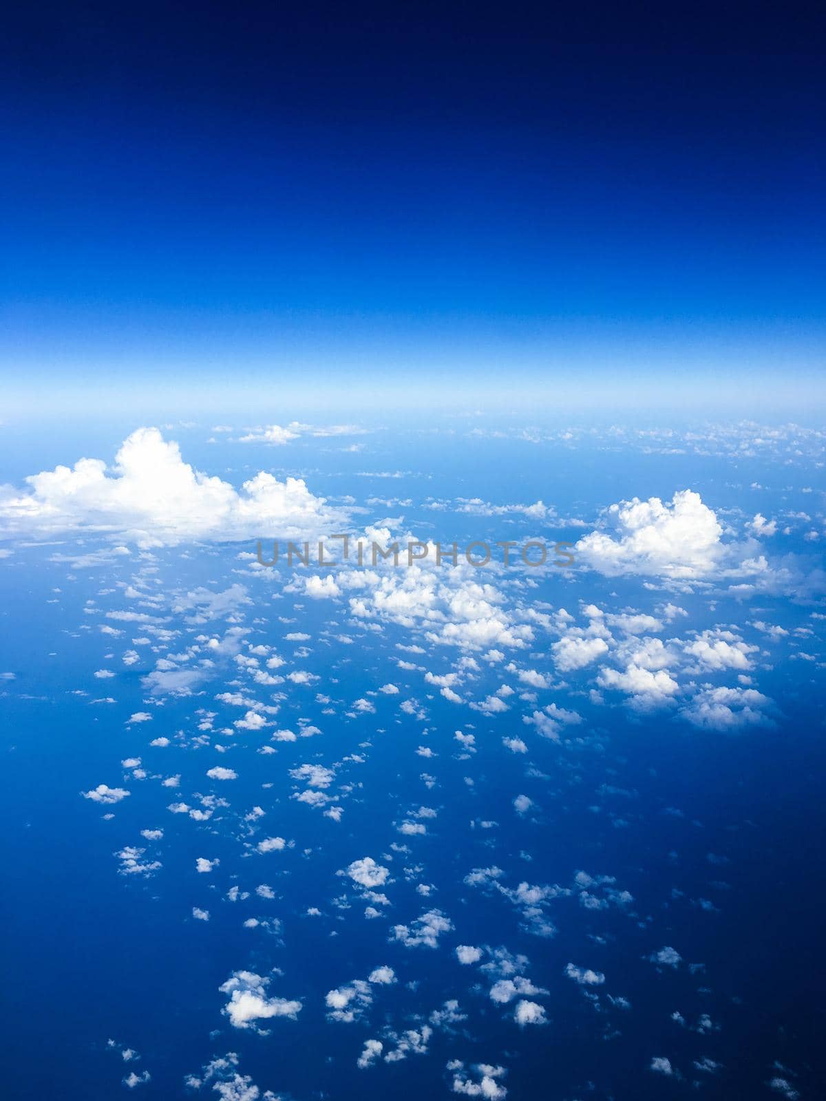 Travel, cloudscape and natural environment concept - View from the airplane window, sky and ocean blue