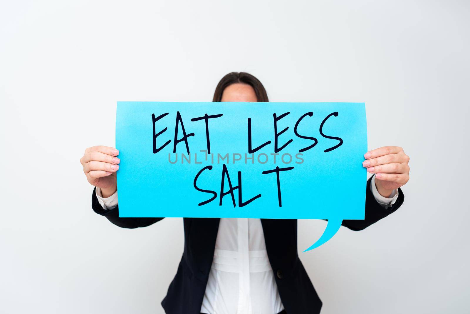 Conceptual caption Eat Less Salt. Word Written on Reduce the amount of sodium in your diet eating healthy Lady in suit holding pen symbolizing successful teamwork accomplishments. by nialowwa