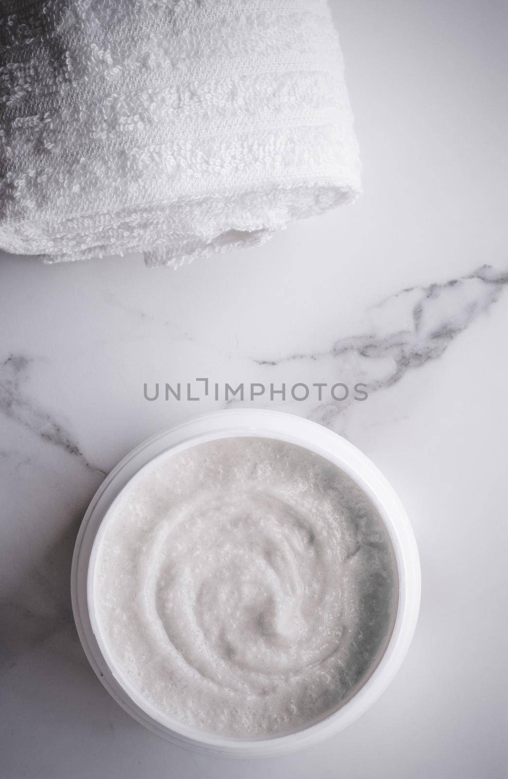 Scrub and exfoliating cream products on a marble, flatlay by Anneleven