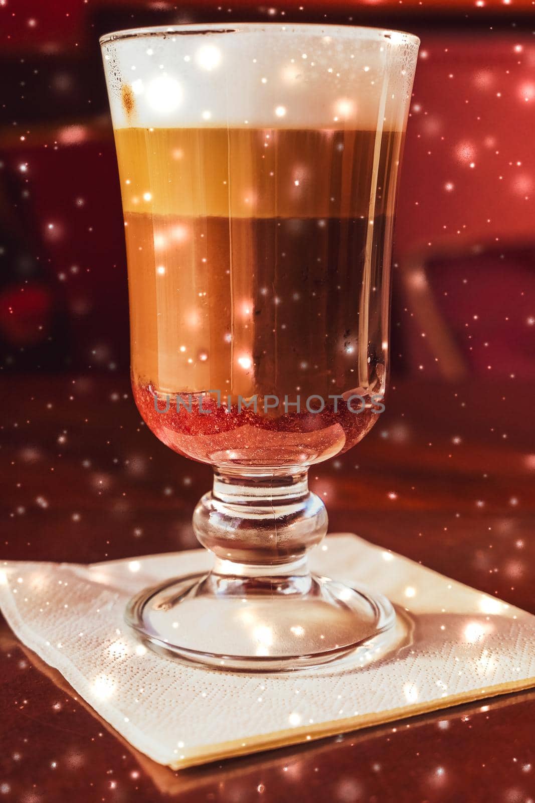 Hot drink, New Years Eve and Valentines Day celebration concept - Winter holiday latte coffee glass and glowing snow in a restaurant, Christmas time menu recipe