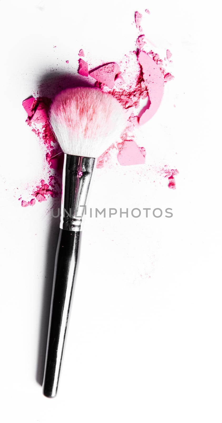 Brush with crushed eyeshadow and powder close-up isolated on white background by Anneleven