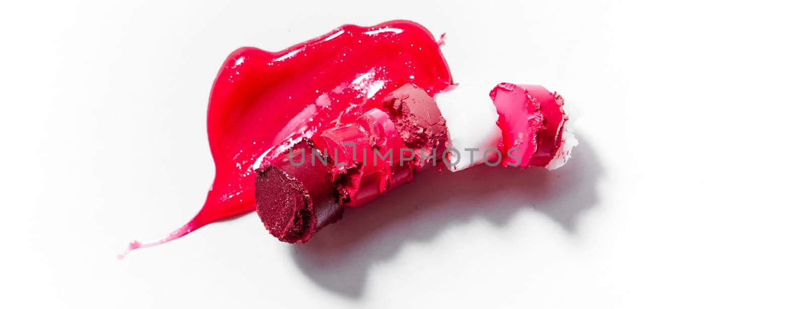 Beauty texture, cosmetic product and art of make-up concept - Cutted and liquid lipstick close-up isolated on white background