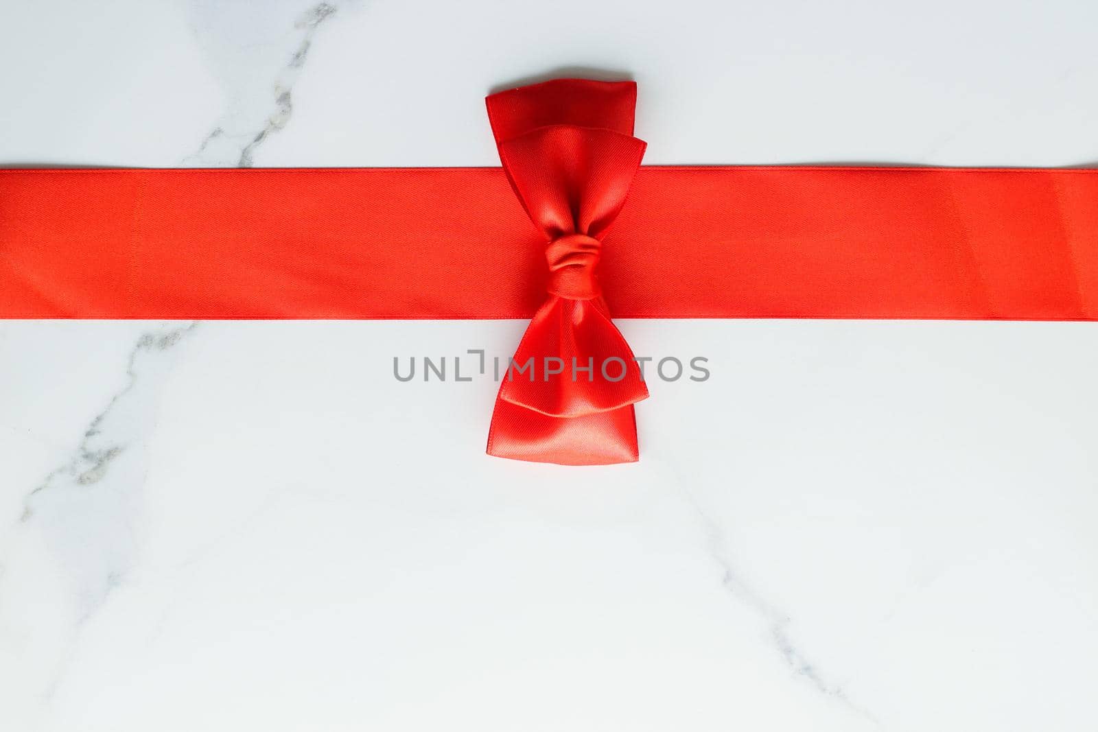 Holiday decor, feminine design and flatlay concept - Red silk ribbon on marble, top view