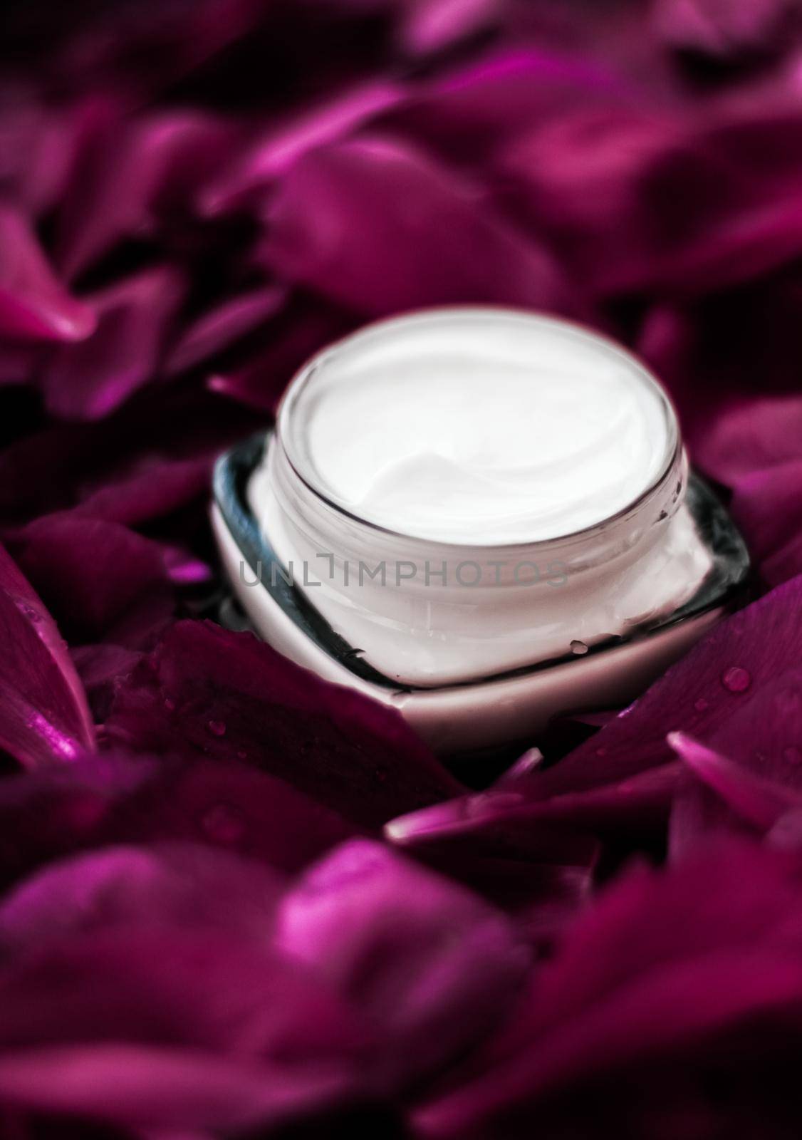Sensitive skincare moisturizer cream on purple flower petals background, natural science for skin by Anneleven