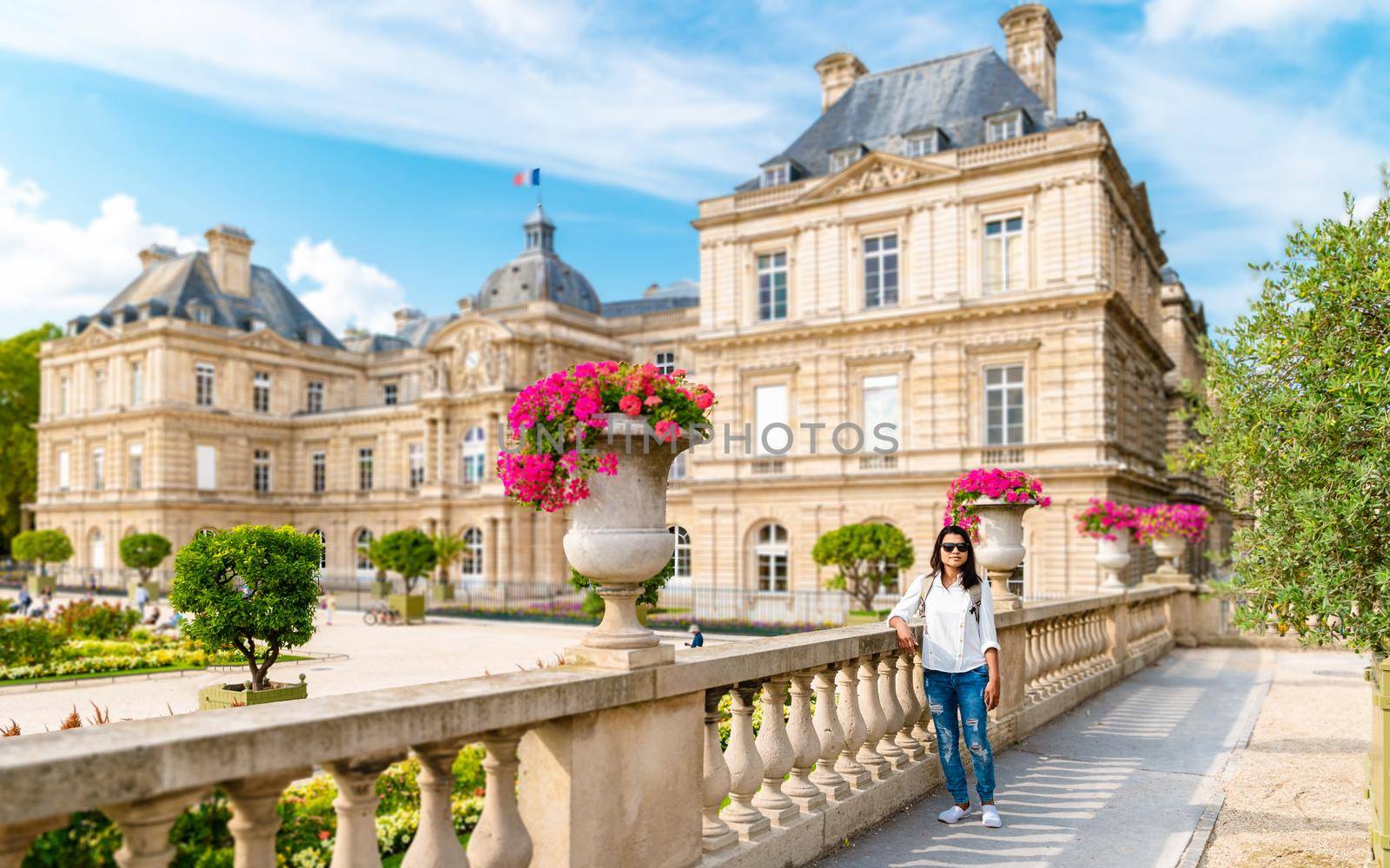 Asian women visit Le Jardin Luxembourg park in Paris during summer, people relax in the park. Jardin du Luxembourg - Jardines de Luxemburgo - Gardens of Luxembourg