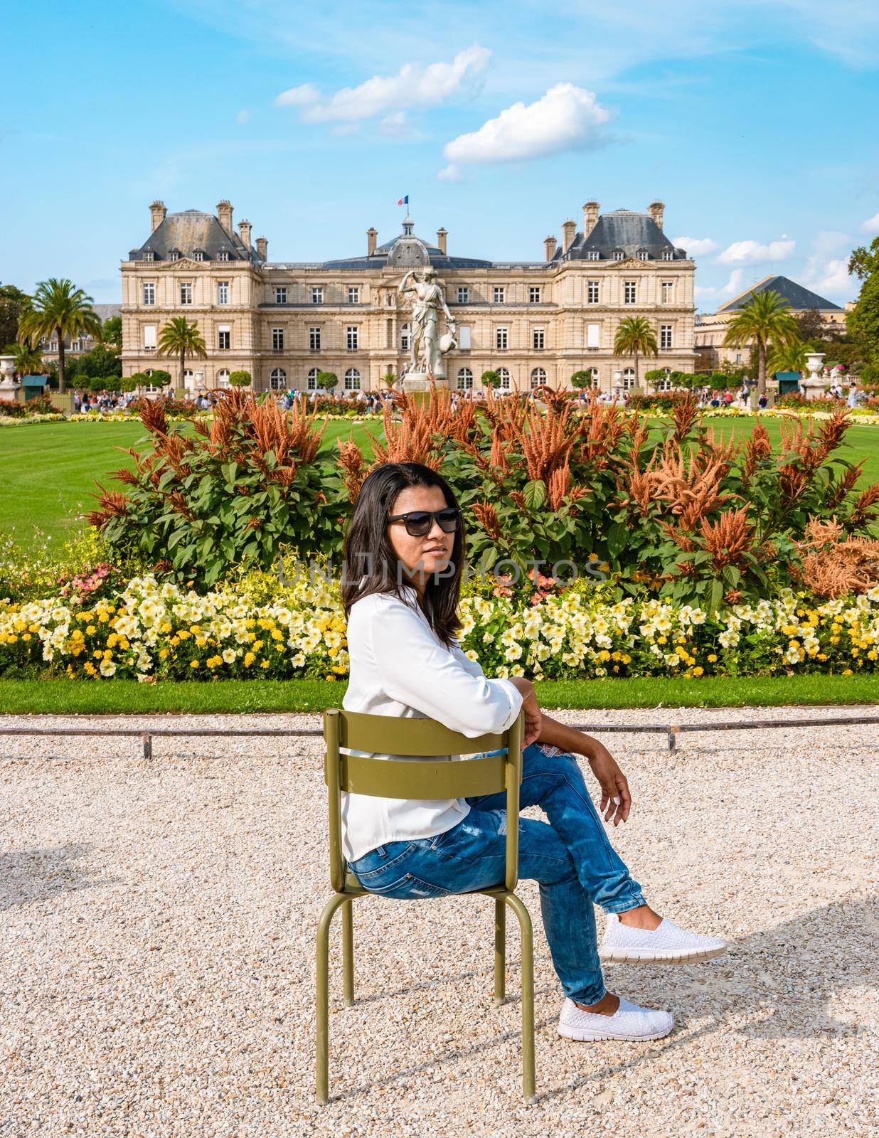 Asian women visit Le Jardin Luxembourg park in Paris during summer, people relax in the park. Jardin du Luxembourg - Jardines de Luxemburgo - Gardens of Luxembourg