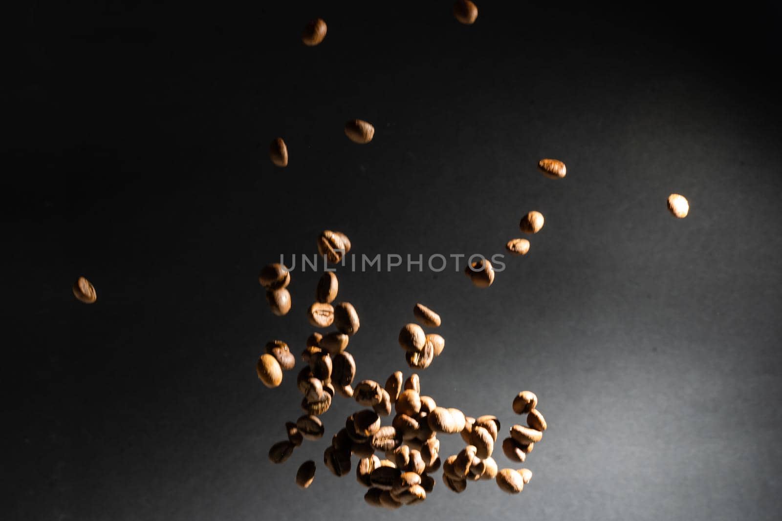 Several coffee beans isolated on black background with reflection. Culinary coffee background