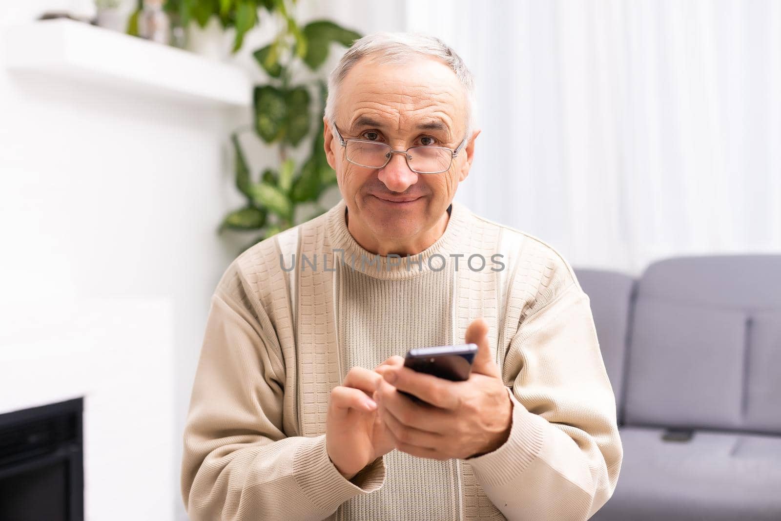 Close up of man hands using smartphone over white table.