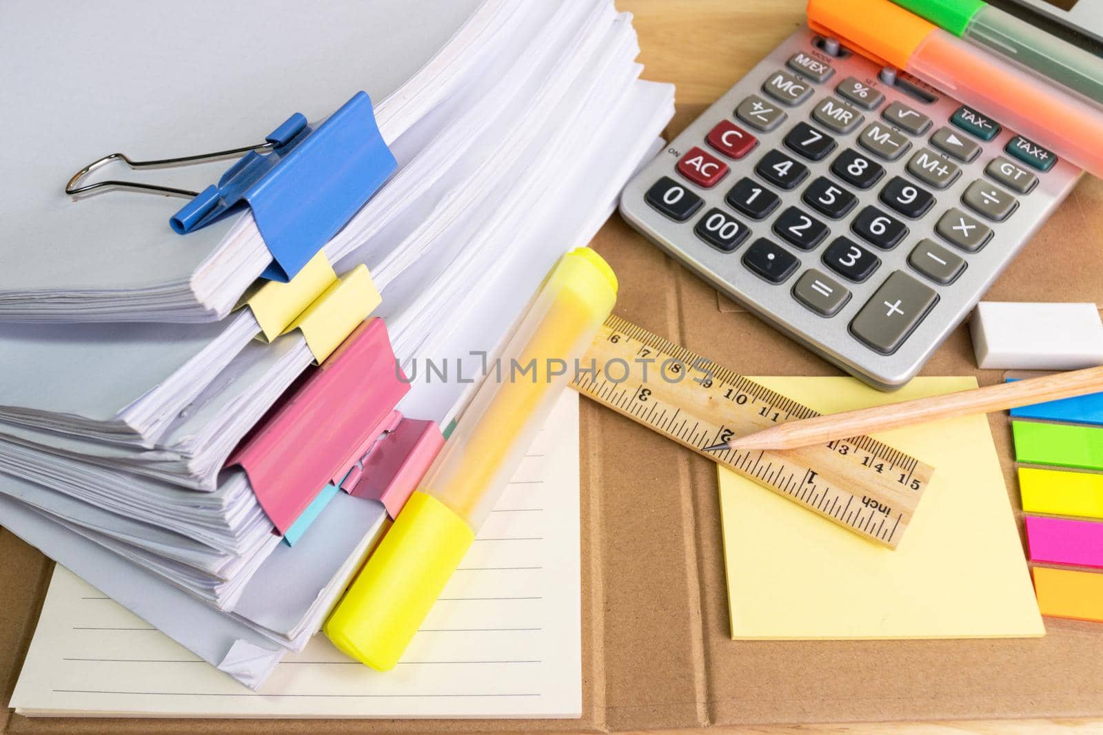 pile of papers with Calculator with pencil eraser ruler at work office for business on the table, concept document in work office