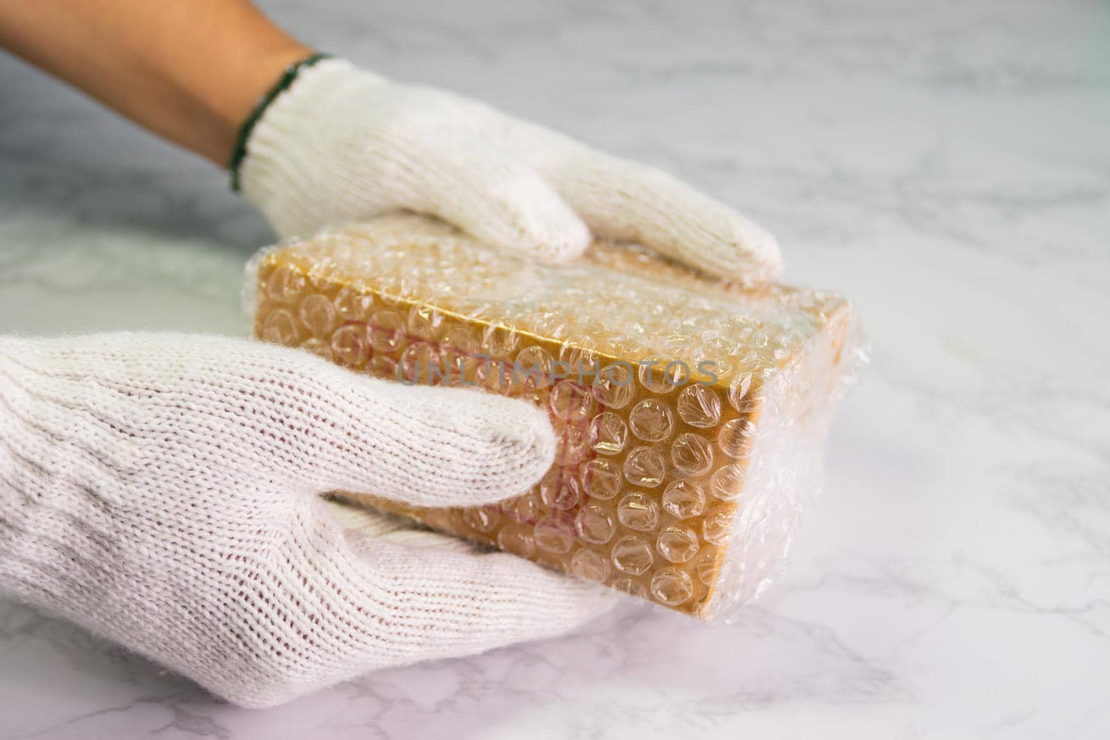hand of man hold bubble wrap, for protection parcel product cracked or insurance During transit by piyaphun